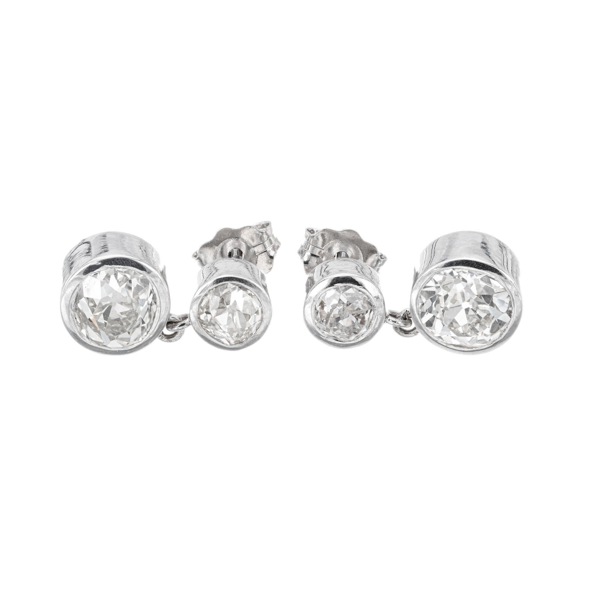 Bezel set old European cut diamond dangle earrings. Handmade in platinum, created in the Peter Suchy workshop.  

1 old European cut diamond, J-K VS approx. .95cts EGL certificate # 400142837D
1 old European cut diamond, J-K VS approx. .94cts EGL