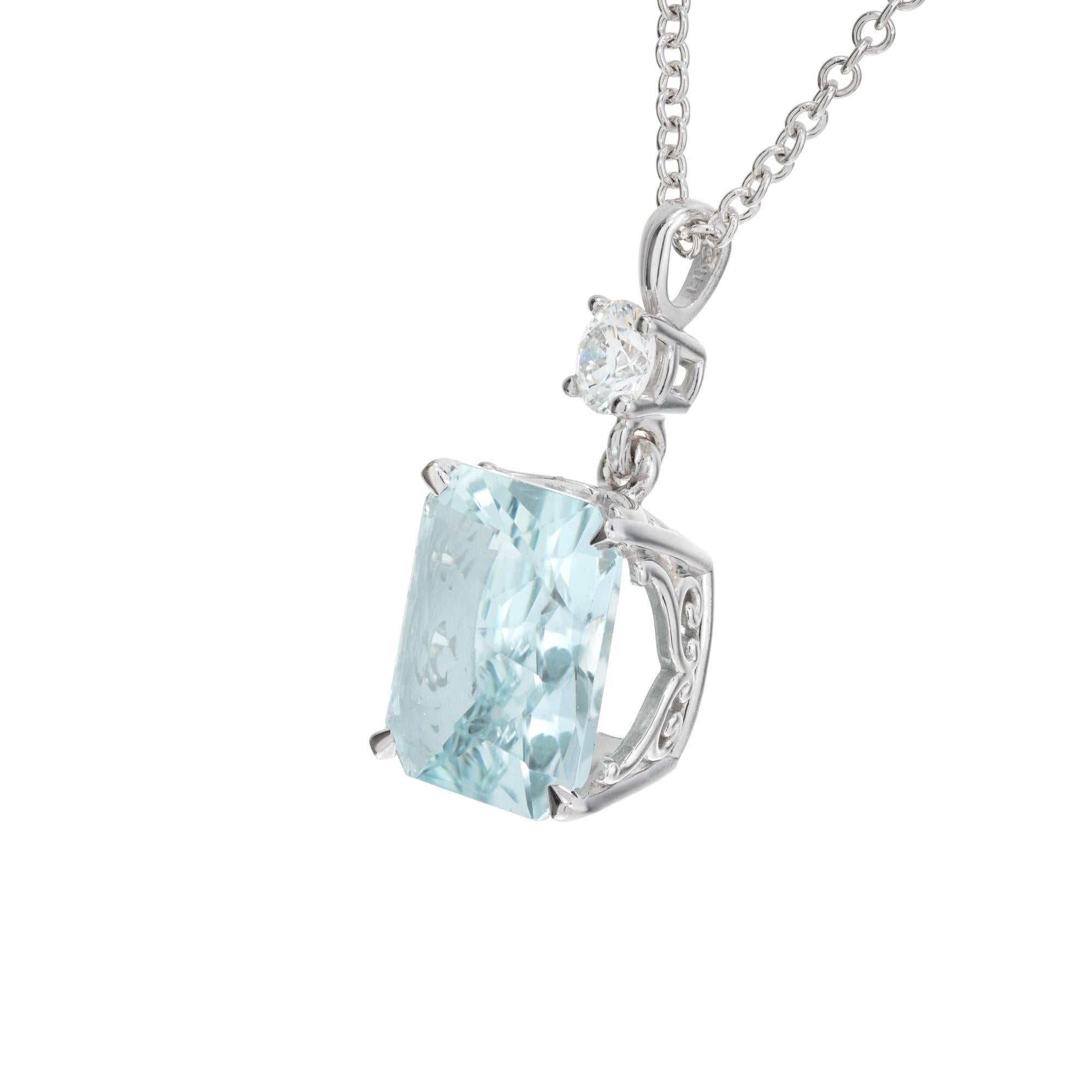 Aqua and diamond pendant necklace. Cushion cut bluish green aquamarine with a round diamond accent on top in a 14k white gold setting. 18 inch 14k white gold chain. Designed and crafted in the Peter Suchy workshop

1 cushion cut blue aquamarine,