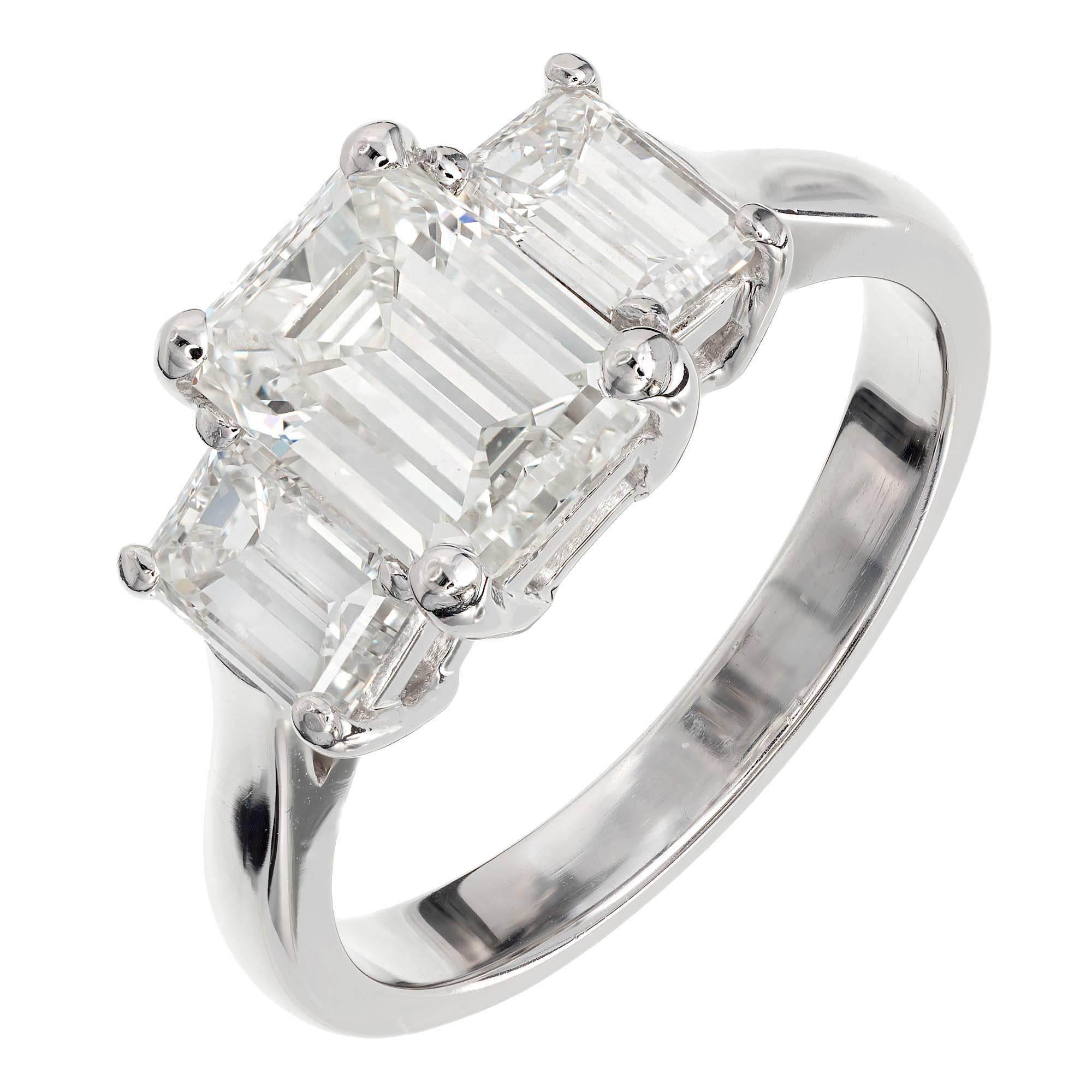 Peter Suchy three-stone handmade platinum diamond engagement ring. Set low to the finger for comfort and designed to fit a wedding band close to the base of the ring. All three diamonds are step cut emerald cut with lots of sparkle and personality