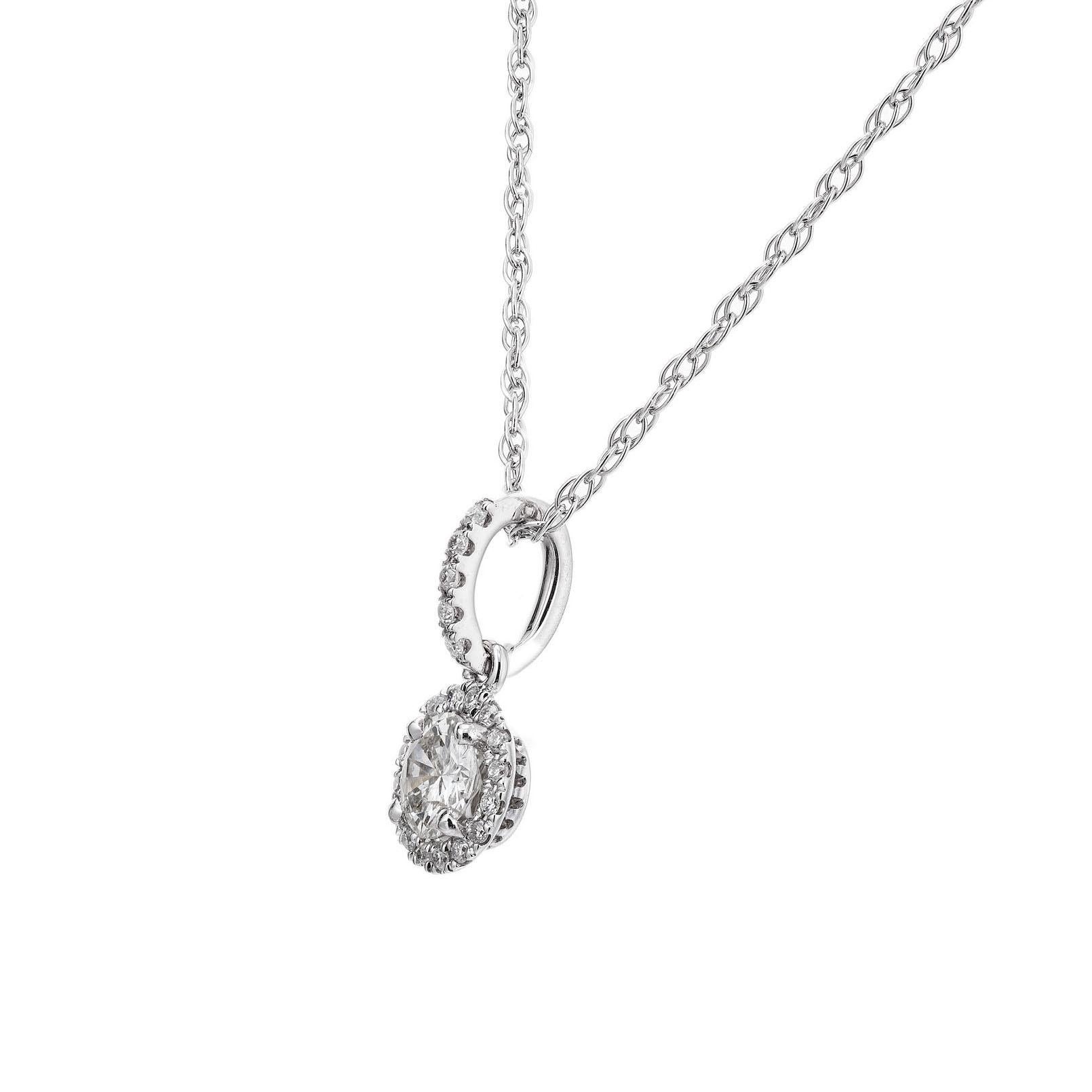 Diamond pendant necklace. .21ct center diamond with a halo of 21 round brilliant cut diamonds, in a 14k white gold setting. 16 inch 14k white gold rope chain. Designed and crafted in the Peter Suchy workshop.

1 round brilliant cut diamond, I-J SI2