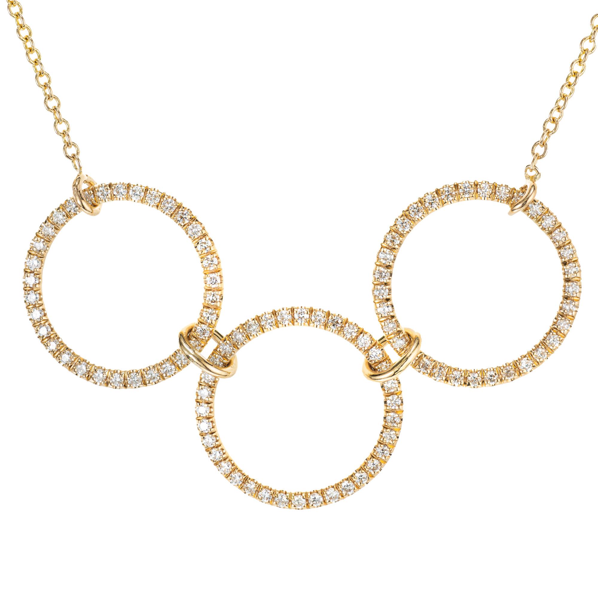 3 ring diamond pendant necklace. Consisting of 3 gold circles connected with gold loops set with 101 brilliant cut diamonds. 16.5 inches. Designed and crafted in the Peter Suchy workshop

101 round brilliant cut diamonds, G VS approx. .28cts
14k