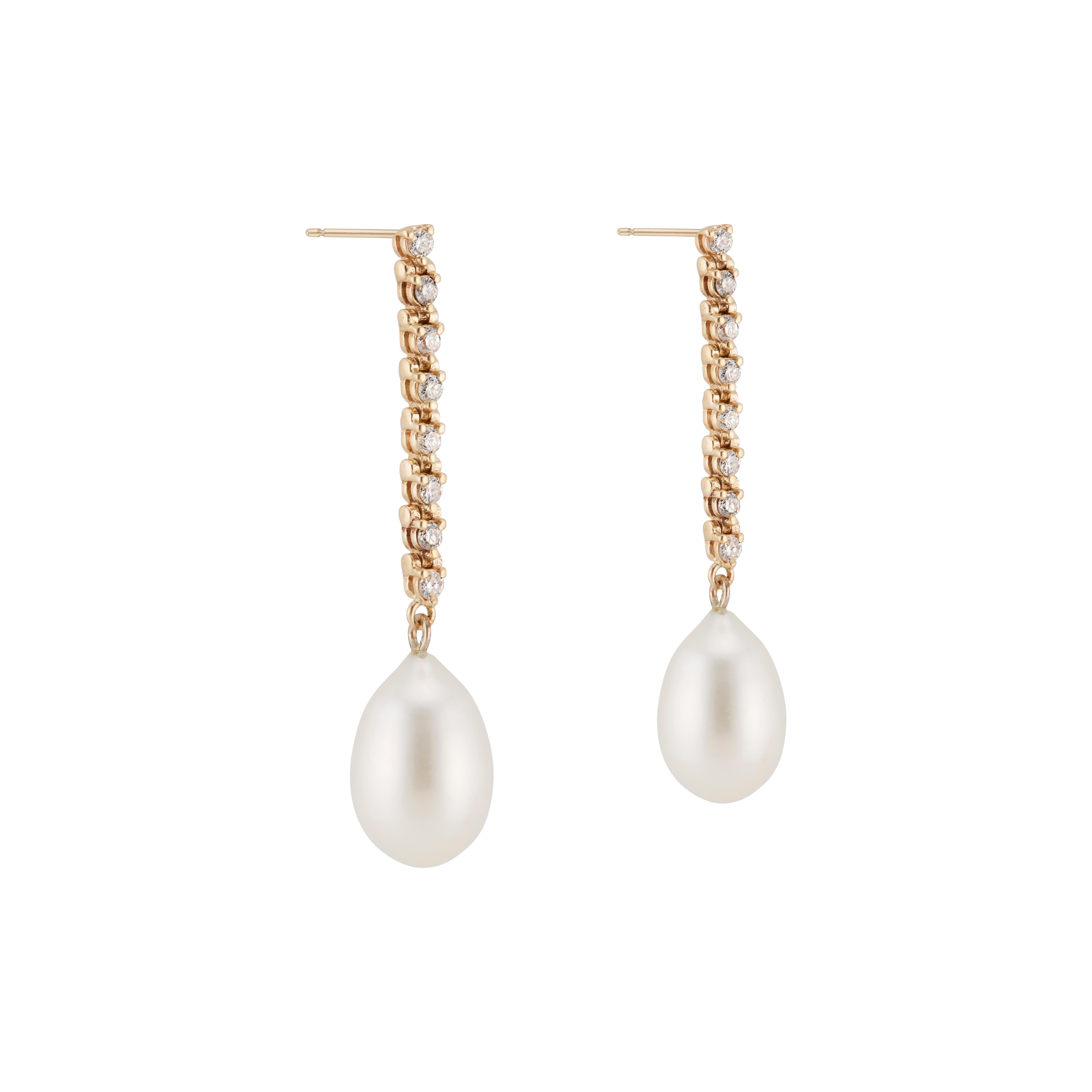 Tear drop shaped freshwater pearl and diamond dangle drop earrings in 14k yellow gold. Designed and crafted in the Peter Suchy workshop

2 elongated freshwater white pearls 14.7mm x 10mm
16 round brilliant cut diamonds, G-H SI approx. .30cts
14k