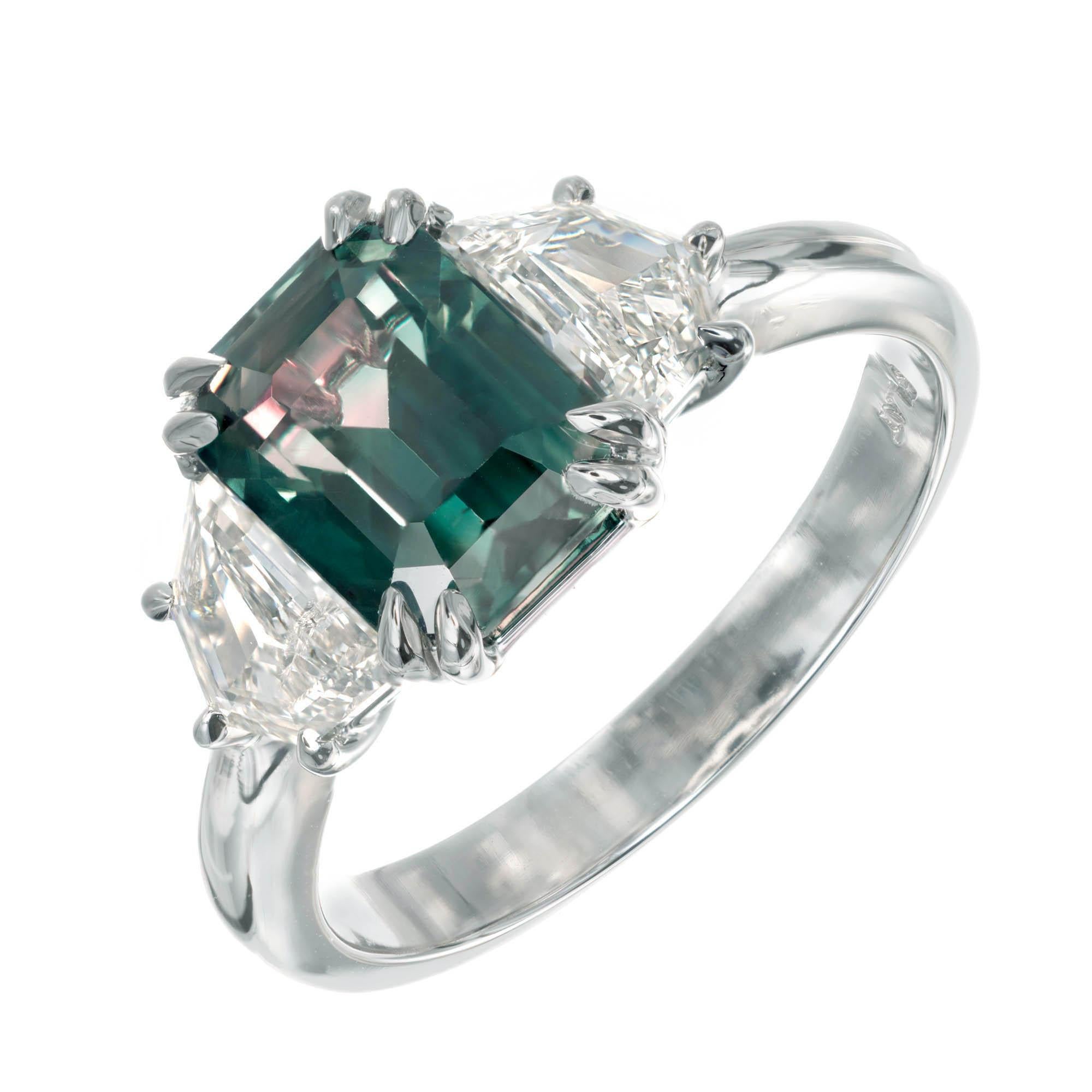 Peter Suchy natural teal (blue/green) octagonal cut sapphire and diamond three-stone engagement ring. The sapphire is from an 1920’s estate in a handmade platinum engagement ring with two Art Deco step cut shield shape diamonds. 

1 Octagonal cut
