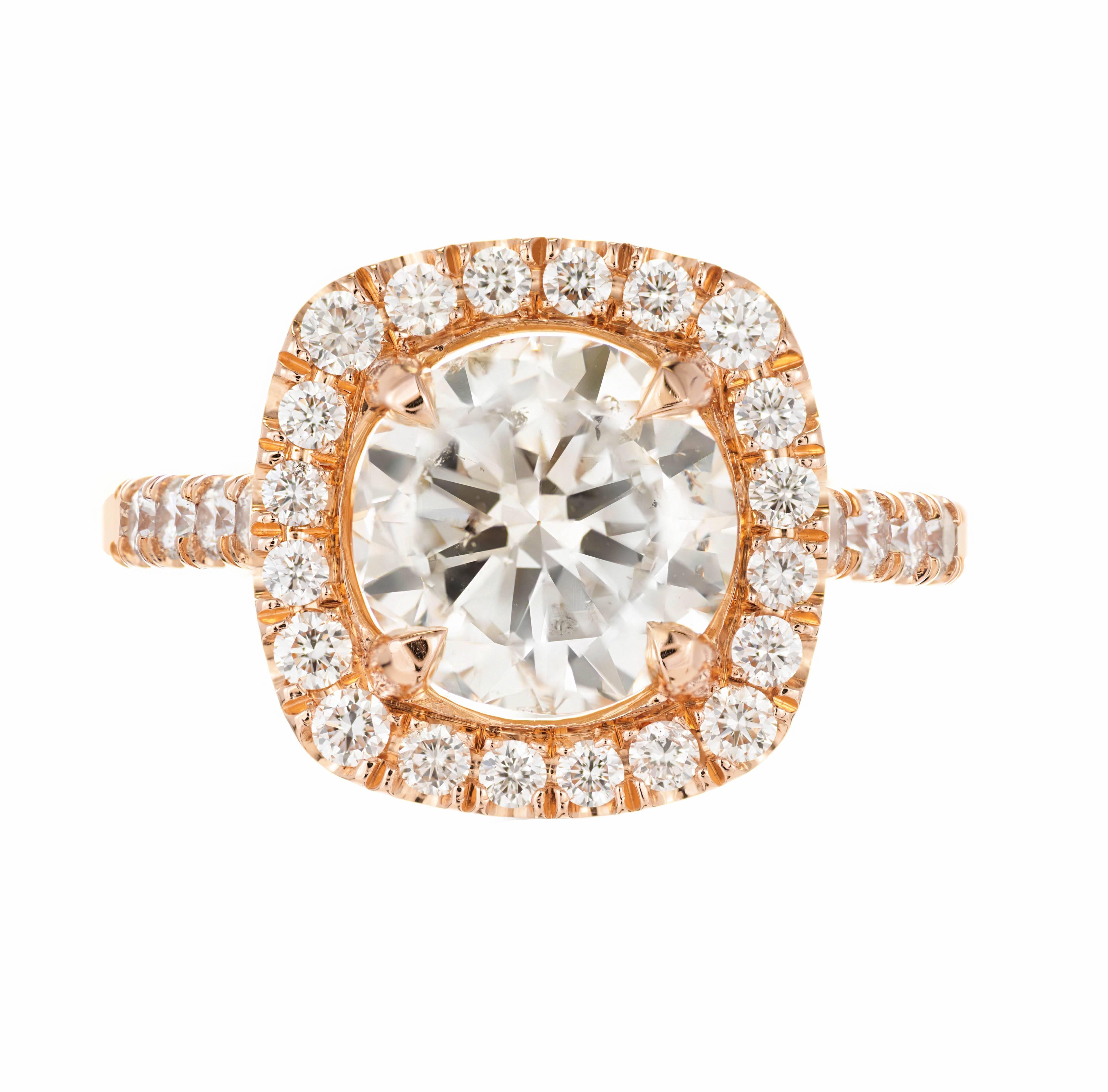 3.04ct transitional Ideal cut diamond halo engagement ring. Slight warm color K that, great sparkle and surface area, no flaws visible to the eye. 18k rose gold setting with diamonds along the shanks. 

1 round brilliant cut diamond, approx. total