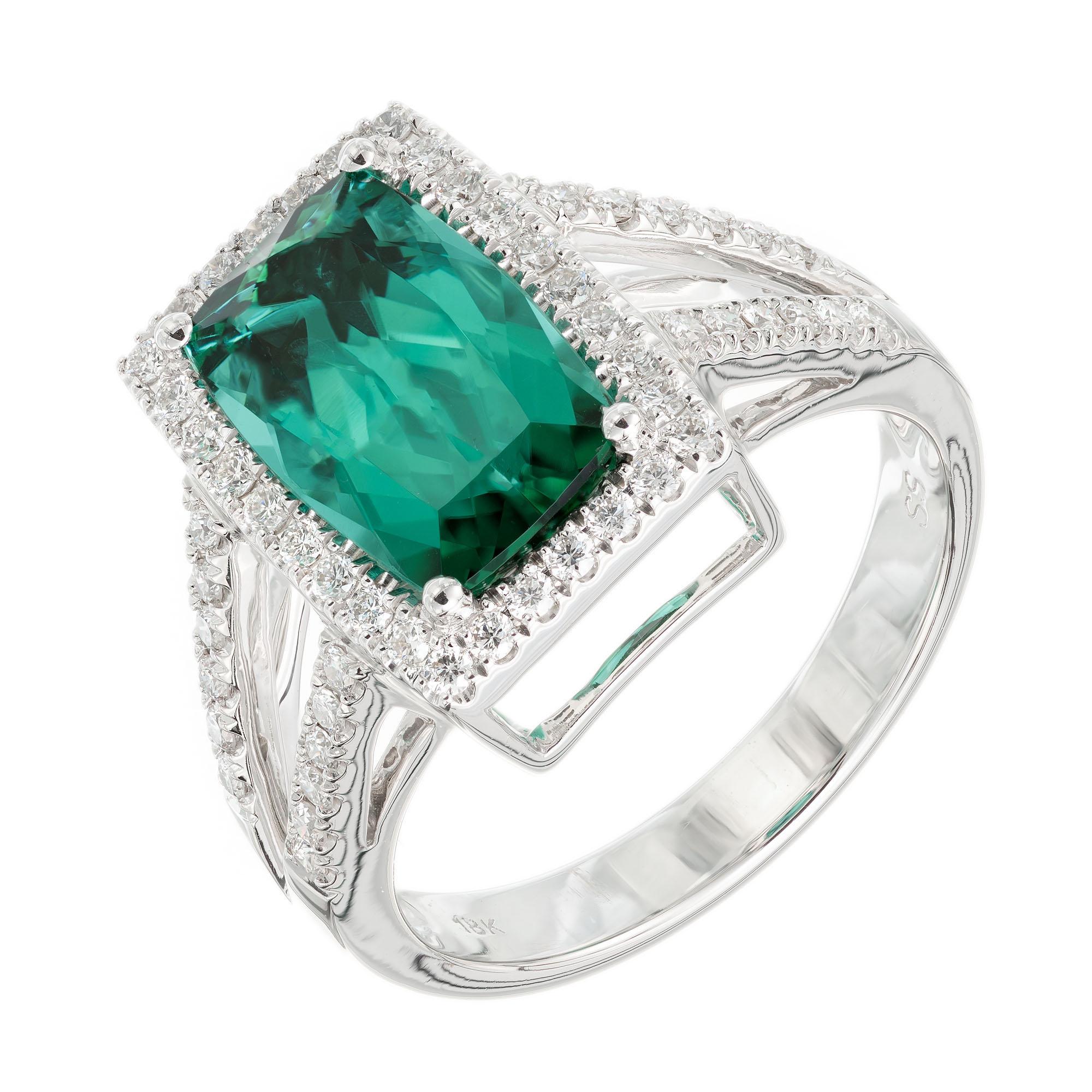 Green tourmaline and diamond cocktail ring. Cushion cut 3.10 carat center stone with a halo of round brilliant cut diamonds in an 18k white gold setting with diamonds along the split shank. Designed and crafted in the Peter Suchy workshop.

1