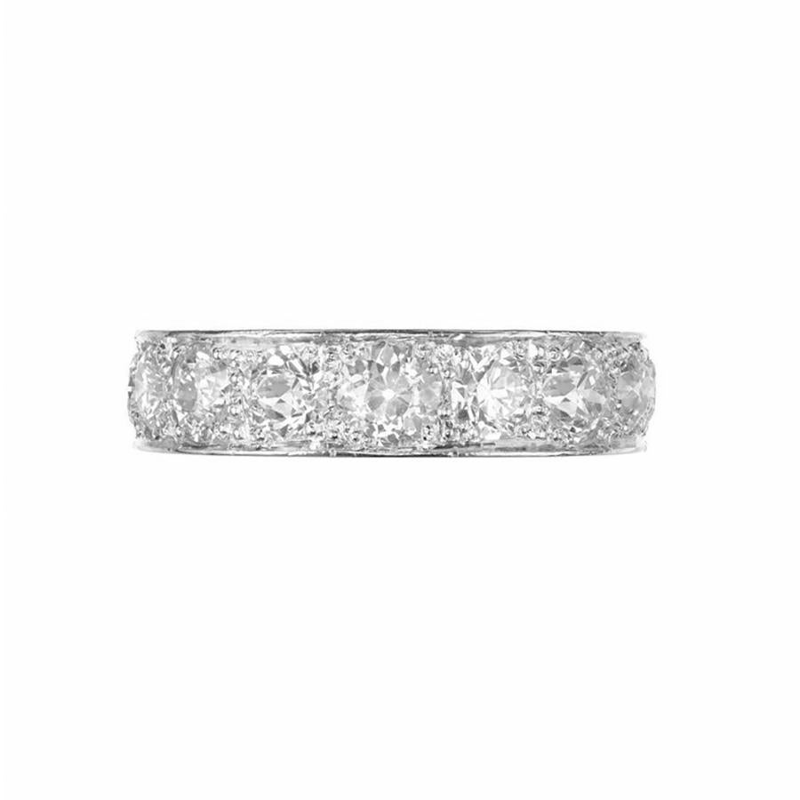 Diamond wedding band ring. This substantial wedding band was inspired by styling of the Art Deco era. It is adorned with 11 round cut diamonds totaling 3.20cts in a Platinum setting designed and created in Peter Suchy Workshop. The diamonds go a