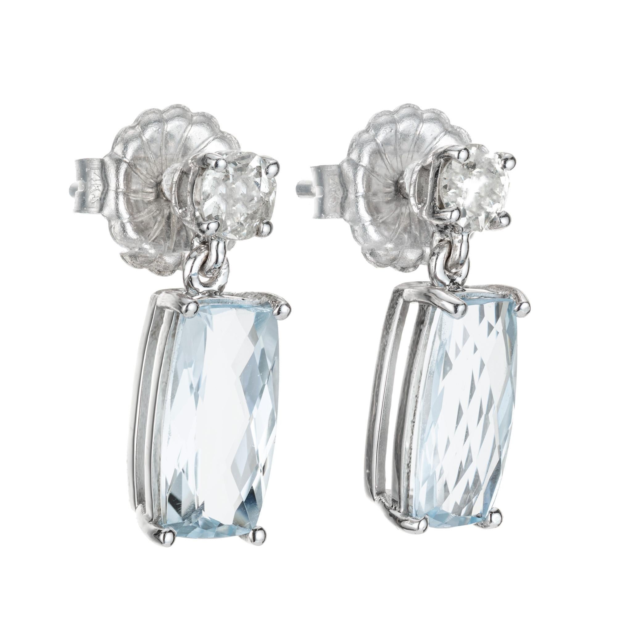 Elongated natural untreated aqua and diamond dangle earrings. 3.24ct elongated cushion cut aquamarines with 2 round old mine cut top diamonds. The stones are circa early 1900's. Designed and crafted in the Peter Suchy workshop

2 elongated cushion
