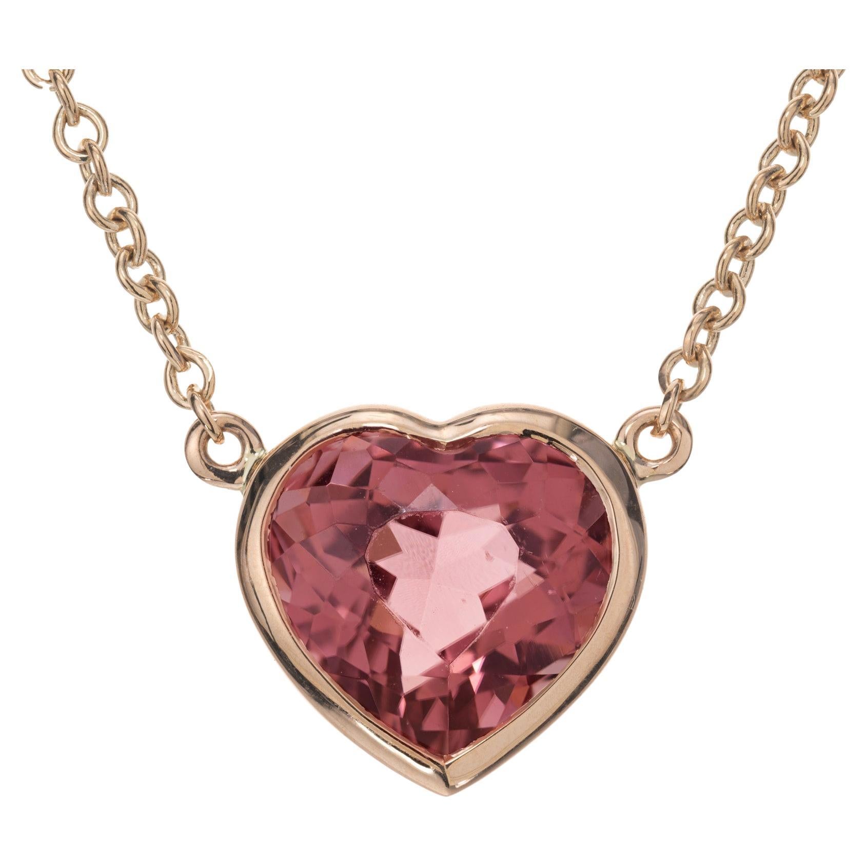 Bright pink tourmaline pendant necklace. 3.29 carat heart shaped tourmaline bezel set pendant in 18k rose gold. 17 inch 18k rose gold chain. Designed and crafted in the Peter Suchy Workshop.
Follow us on our 1stdibs storefront to view our weekly new