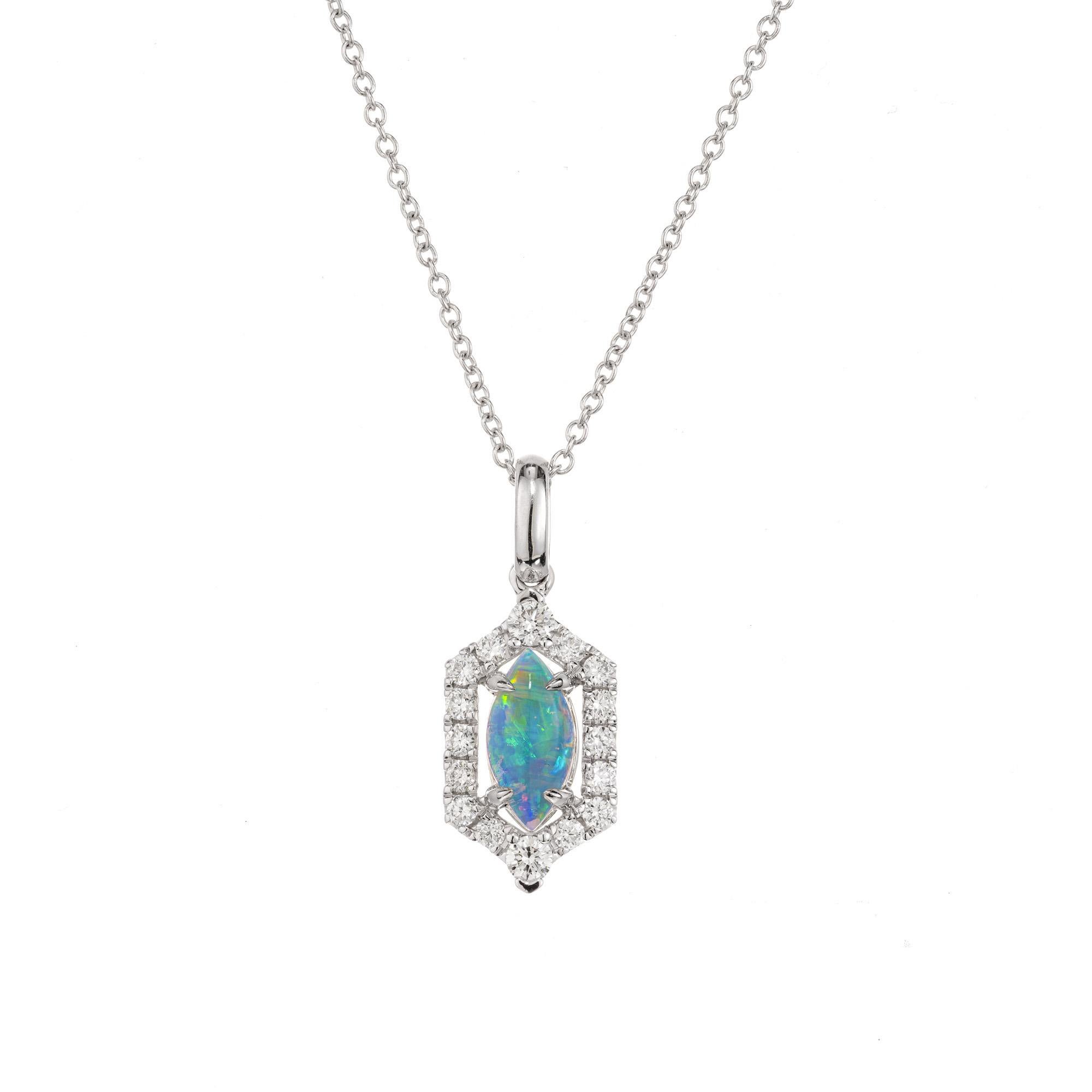 A timeless modern .33 carat marquise opal with red flash over a strong blue-green body color surrounded by a halo of 16 round brilliant cut diamonds mounted in a 14k white gold pendant mounting. 18 inch 14k, white gold chain, The contrast between