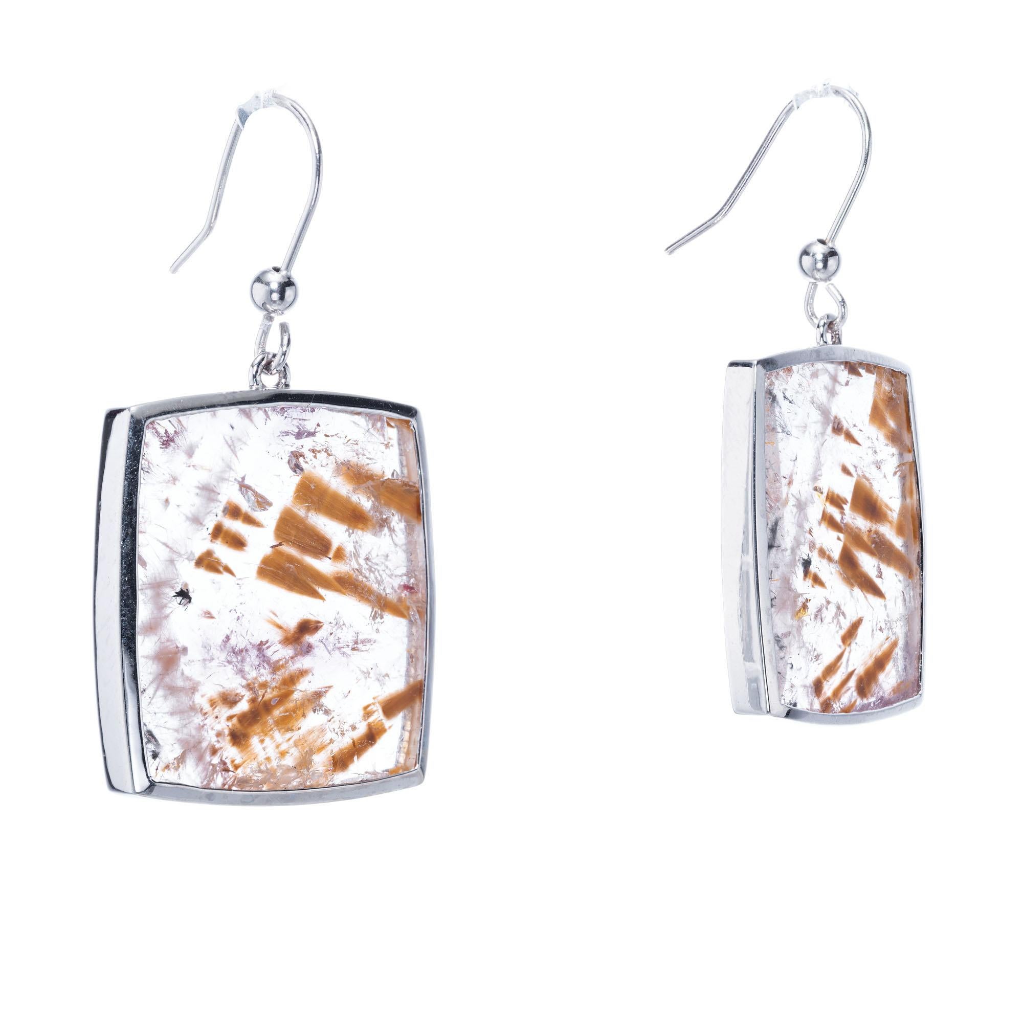 Natural clear Quartz crystal square's with mineral inclusions, set in handmade 18k white gold dangle settings, crafted in the Peter Suchy Workshop.

Natural clear Quartz with natural Cacoxenite and iron inclusions, approx. total weight 34.96cts
18k