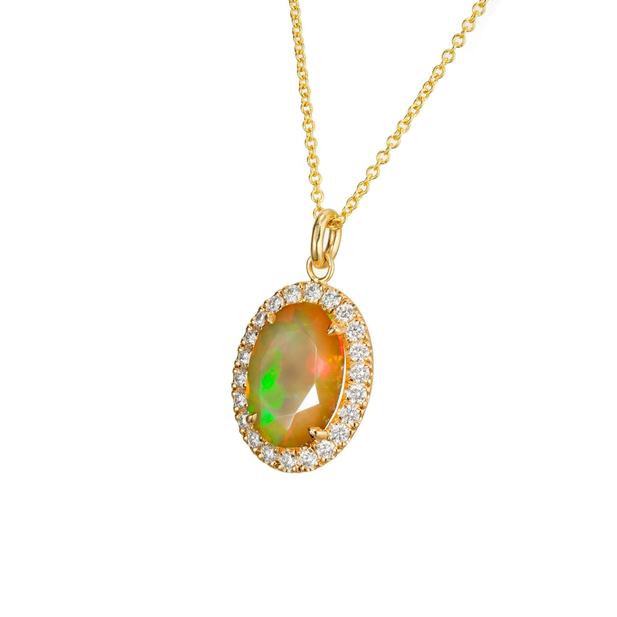 Oval faceted reddish, green, orange opal and diamond pendant. 3.50ct Oval opal with a halo of  22 round brilliant cut diamonds. 18k yellow gold setting and 18 inch chain. The pendant was designed and crafted in the Peter Suchy workshop.

1 oval
