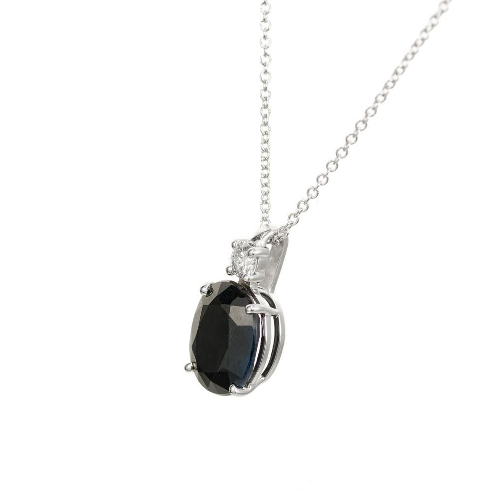 Dark and rich blue sapphire and diamond pendant necklace. 3.51 oval sapphire set in a classic 4 prong 14k white gold setting, accented with a .13cts round brilliant cut diamond. 18 Inch chain. Designed and crafted in the Peter Suchy Workshop.

1