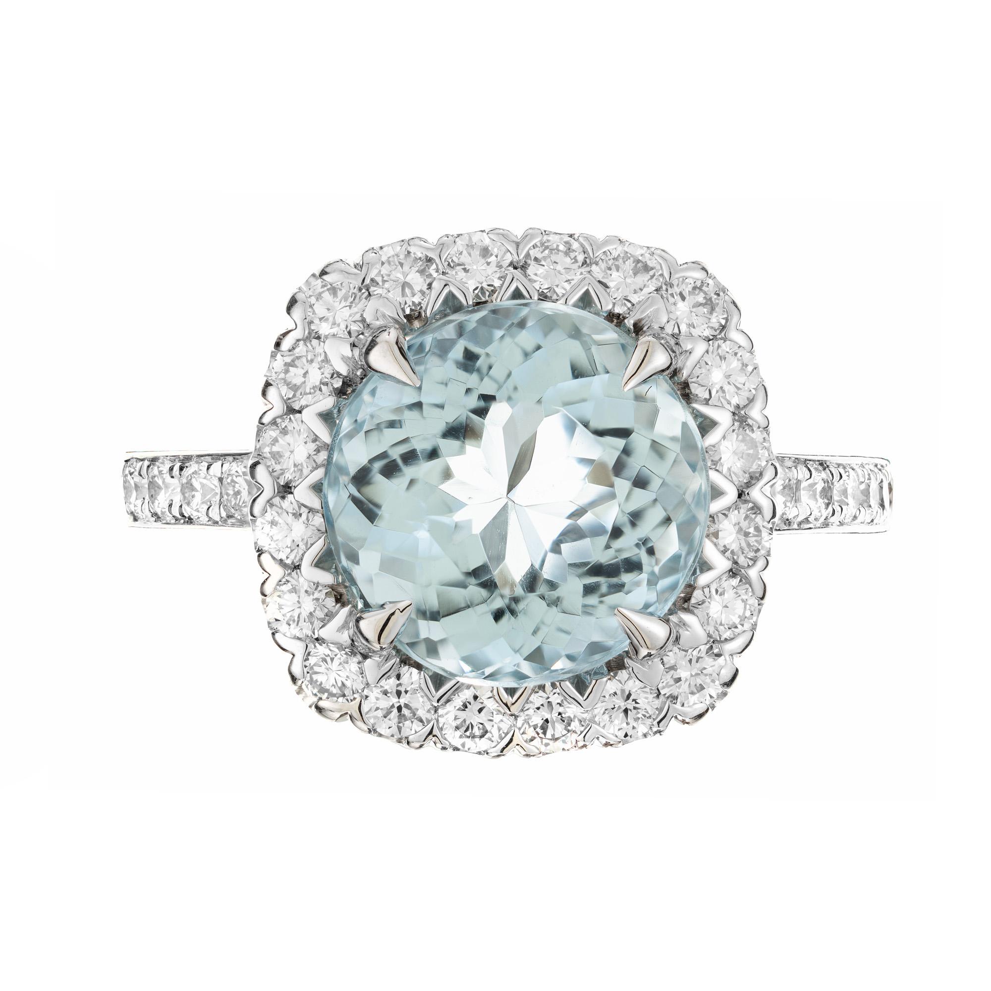 Bright, well cut Old European cut aqua from a 1910 estate. Natural, slightly greenish blue aqua in a secure and durable 
Aquamarine and Diamond halo platinum engagement ring. This beautiful ring begins with a round 3.66ct center aquamarine that is