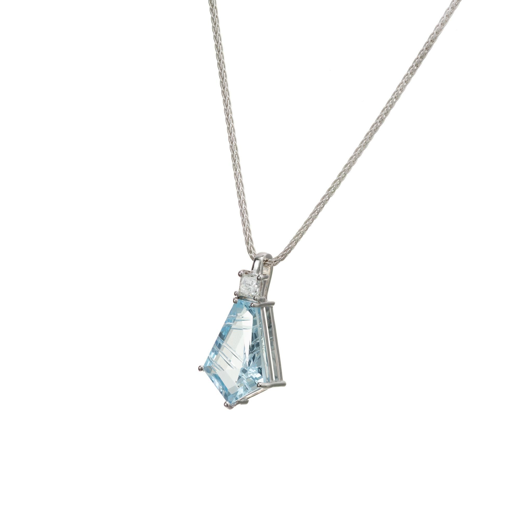 Aqua and diamond pendant necklace. 3.70 carat kite shaped fantasy cut aqua with a princess cut accent diamond set in 14k white gold. 18 inch long. Designed and crafted in the Peter Suchy workshop

1 kite shaped blue aquamarine with cuts, approx.