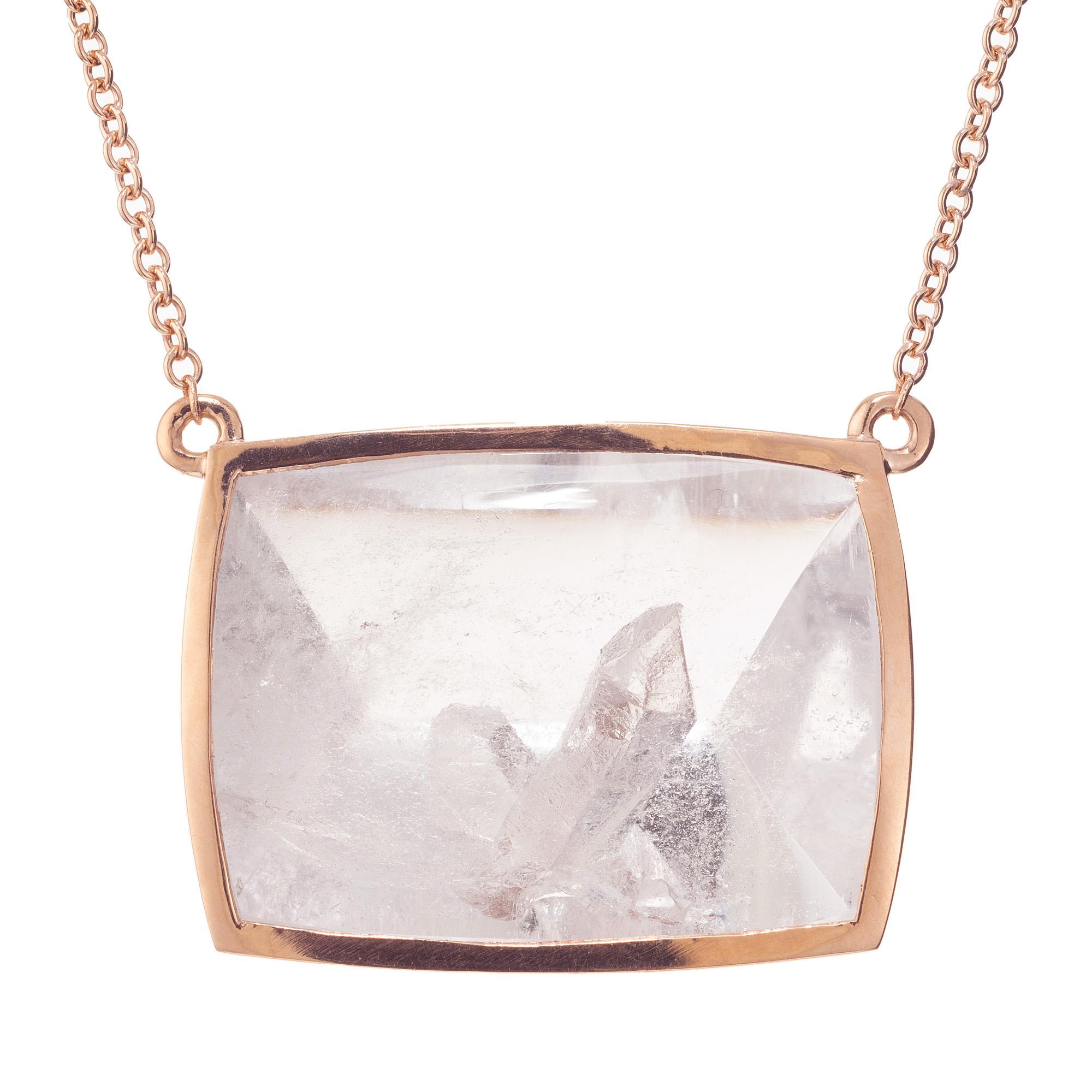 Manifestor crystals are almost the rarest of all Quartz formations. This 38.44ct custom cut crystal is framed in 14k rose gold and completed with a 18.75 inch necklace. A Quartz crystal grows to a finished form and is then later encased in Quartz