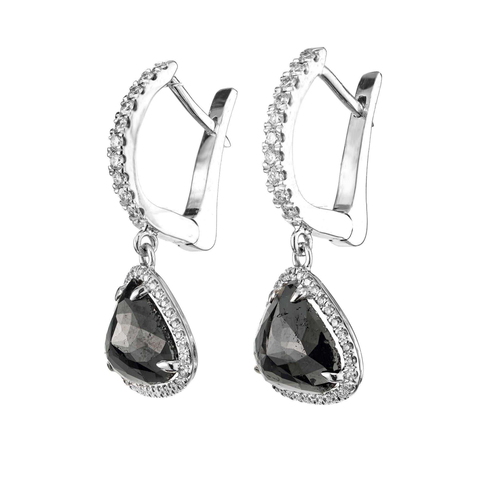 Peter Suchy black diamond halo dangle earrings. Set with 2 black modified step cut heart shapes diamonds with a total weight of 3.89cts. Each stone is surrounded by a halo of round cut diamonds. Set in 18k white gold with diamonds along the upper