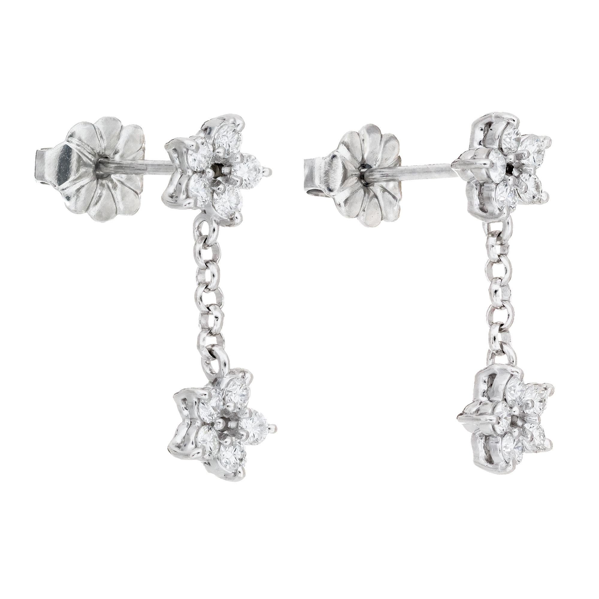 Peter Suchy double star design platinum dangle drop earrings.  

20 round brilliant cut diamonds, F-G VS approx. .40cts
Platinum 
Stamped: PT950
2.2 grams
Top to bottom: 16.9mm or 2/3 Inches
Width: 5.5mmm or .25 Inch
Depth or thickness: 2.7mm 
