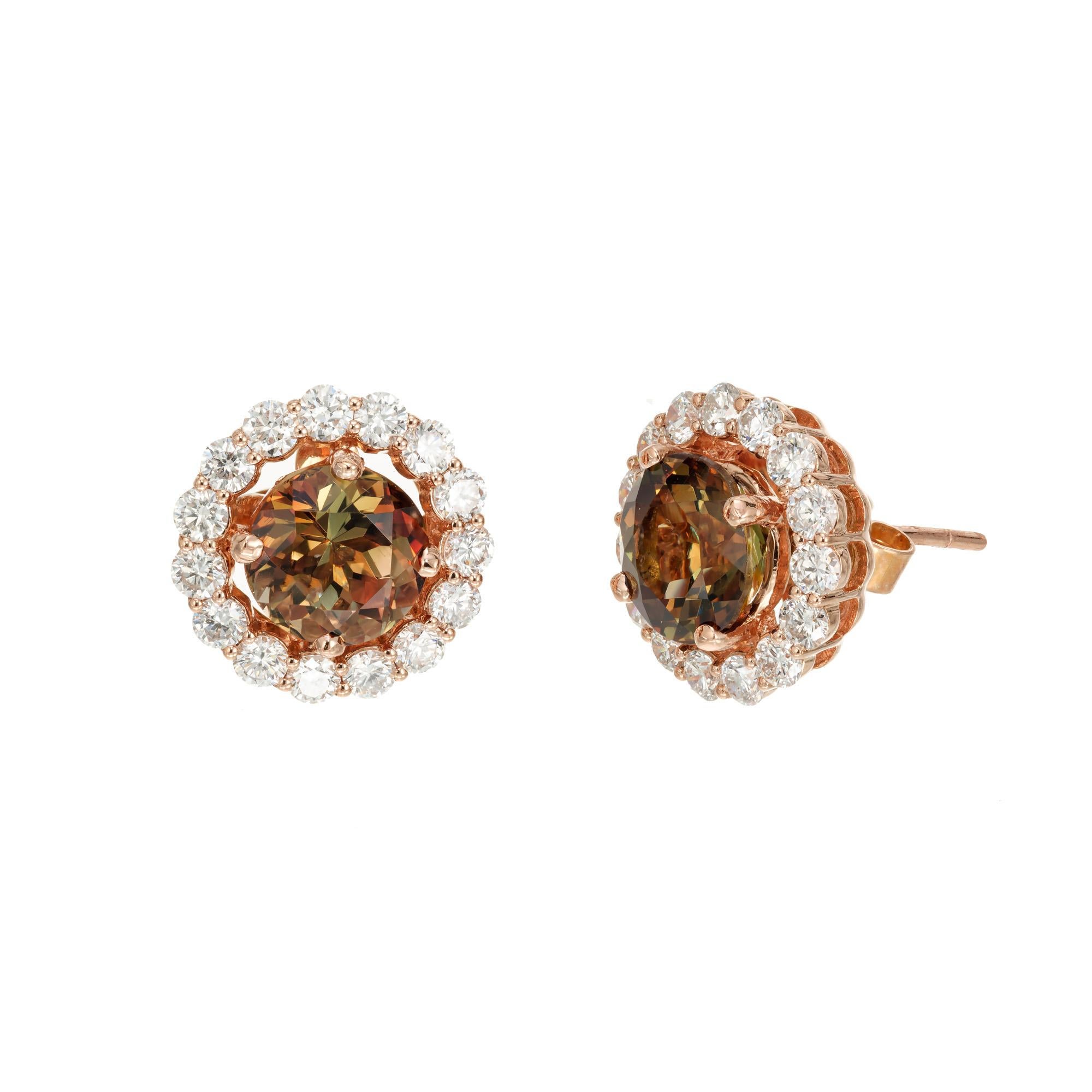 Andalusite and diamond earrings. 2 round Andalusite set in 18k rose gold settings each with round diamond halos. Andolusite bright color change in the brown, orange and green range. Designed and crafted in the Peter Suchy Workshop.

2 round brownish