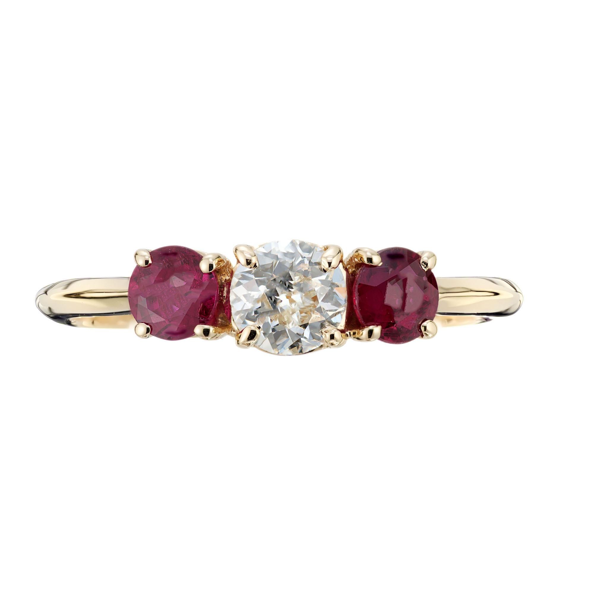 Diamond and ruby engagement ring. Old European cut center diamond set with two red natural rubies in a classic 18k yellow gold three-stone setting. Created in the Peter Suchy Jewelers Workshop. 

1 old European cut diamond, G VS approx. .42cts
2