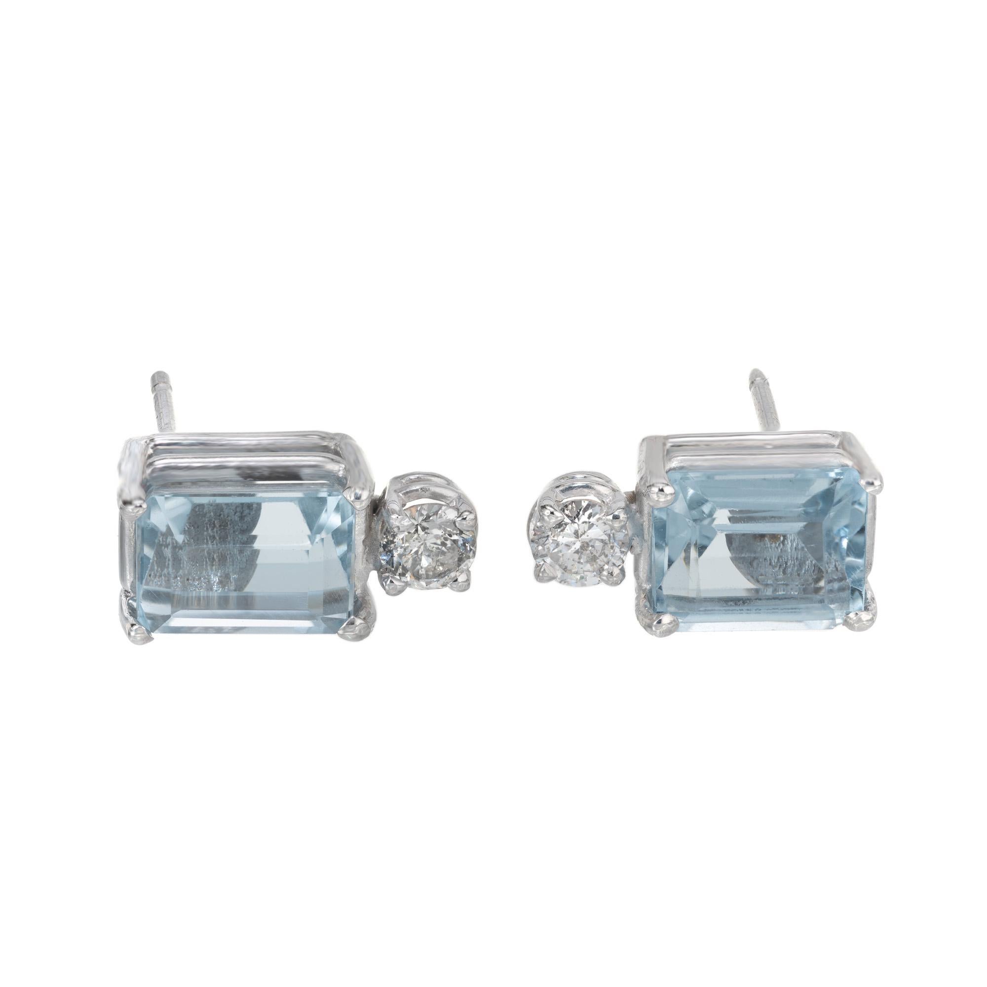Aqua and diamond earrings. 2 Emerald cut rich aquamarines set in 14k white gold 4 prong settings. Each aqua is accented with 2 round brilliant cut diamonds. Designed and crafted in the Peter Suchy Workshop.

2 emerald cut blue aquamarines, approx.