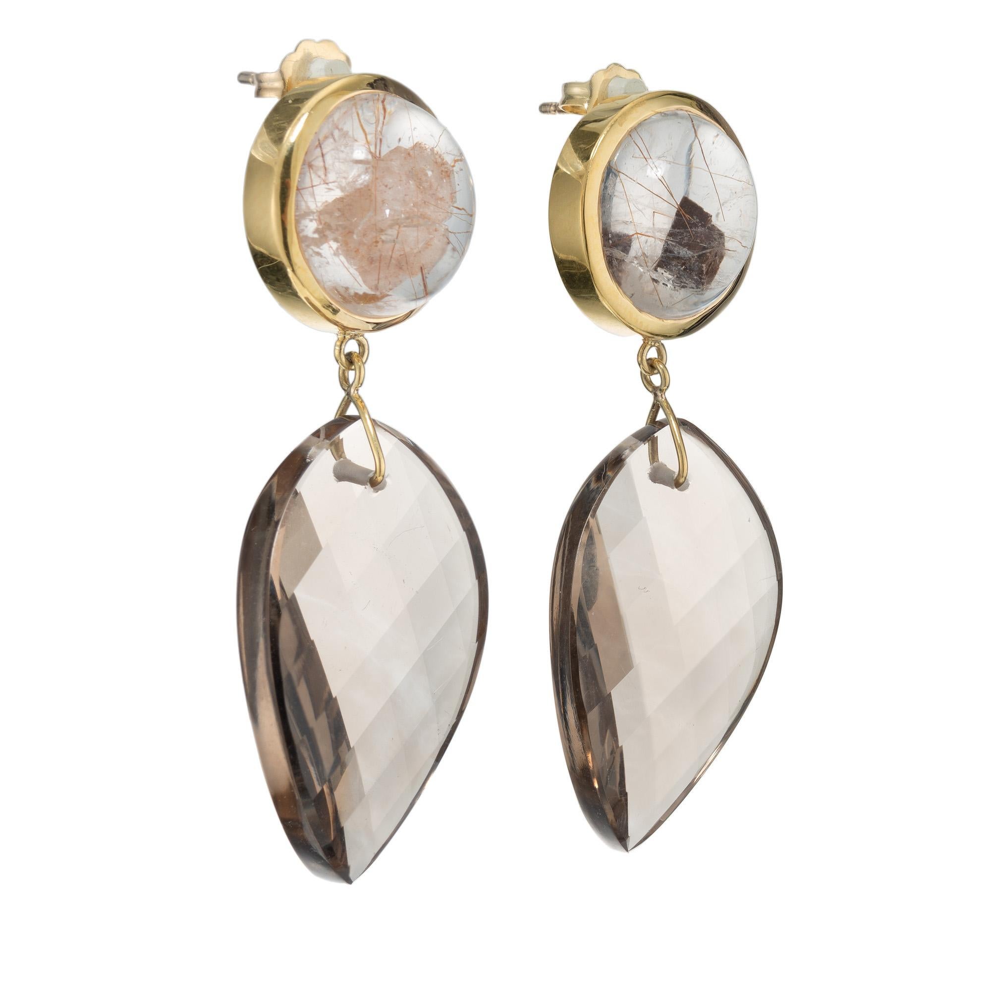 Peter Suchy 44.34 Carat Manifestor Quartz Gold Dangle Earrings. These exquisite earrings are a true statement piece, showcasing a striking pair of 44.34 carat checkerboard flame twist shape quartz crystal. They are suspended from 2 round 18k yellow
