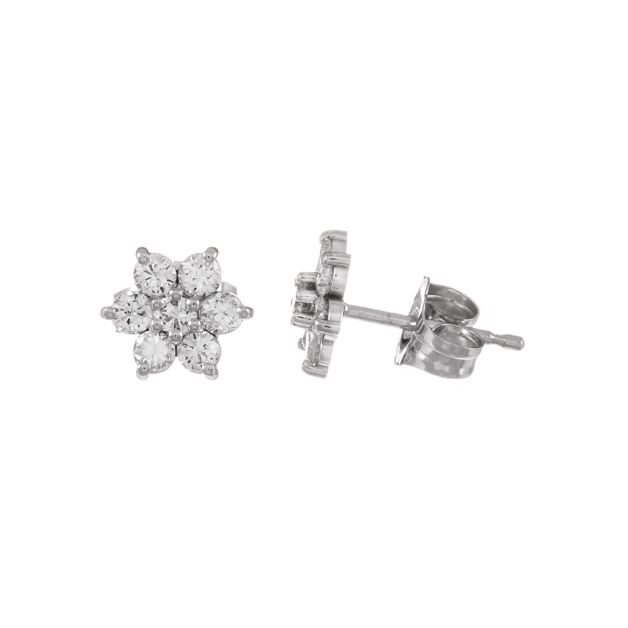 Diamond flower cluster earrings set in 14k white gold.

14 round brilliant cut diamonds G VS-SI, approx. .46ct
14k white gold 
.8 grams
Top to bottom: 6.39mm or .25 Inch
Width: 6.39mm or .25 Inch
Depth or thickness: 2.3mm
