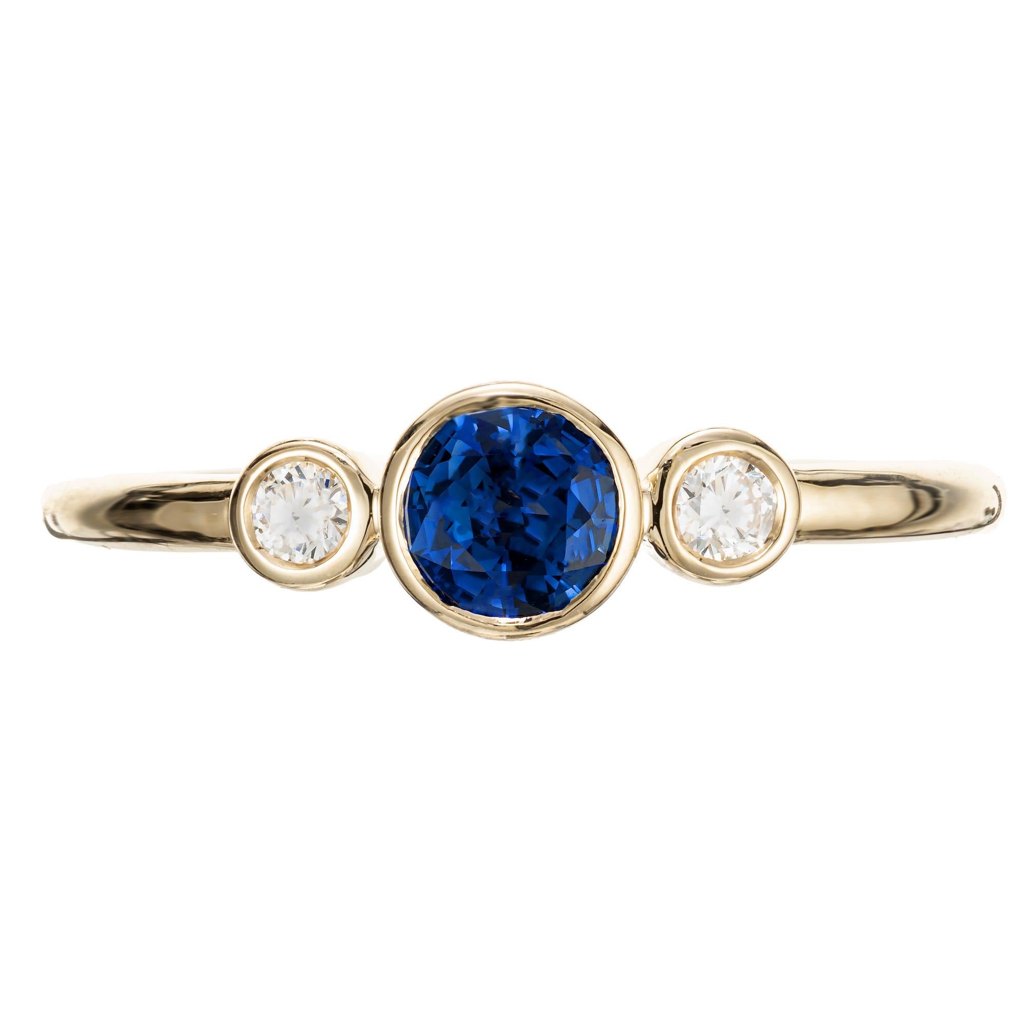 Sapphire and diamond engagement. 1 round .46ct bezel set sapphire center stone with 2 bezel set round cut diamonds in a 18k yellow gold setting. Designed and crafted in the Peter Suchy workshop

1 round blue sapphire, approx. .46cts
2 round