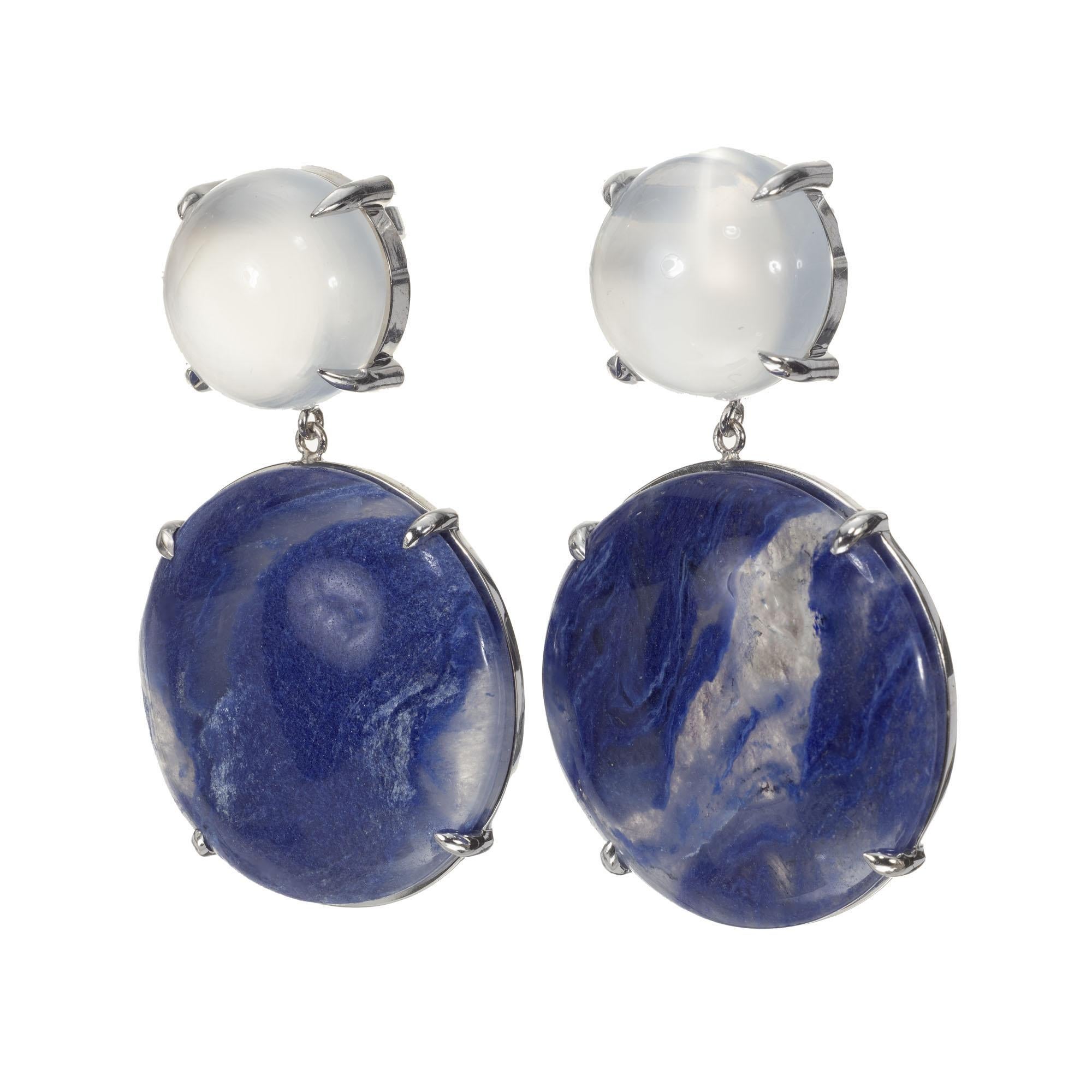 Peter Suchy moonstone and blue quartz dangle earrings in 14k white gold. Two 12.50ct moonstone tops with two 34.19ct blue quartz dangles. 

2 round cabochon white irradiated moonstones, approx. 12.5cts
2 round marbled blue cabochon quartz, approx.
