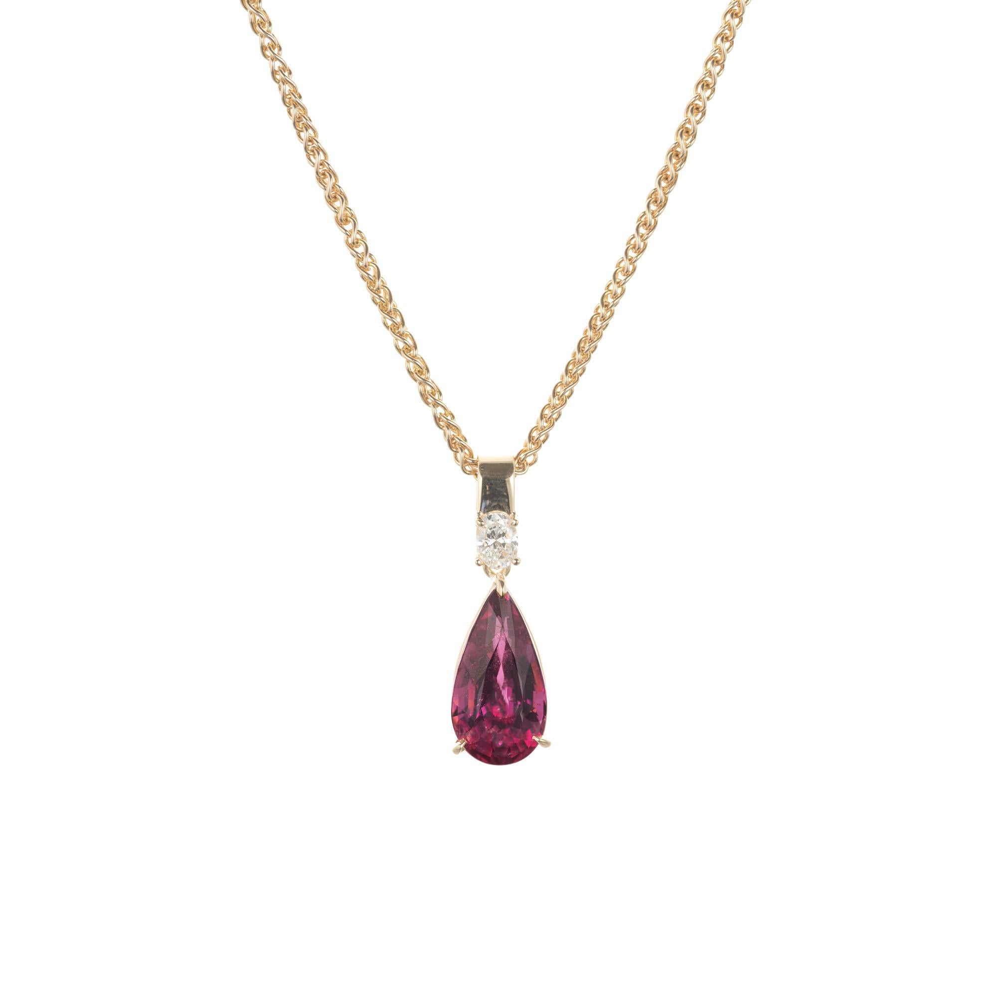 Pink tourmaline and diamond pendant necklace. Pear shaped pink tourmaline, accented with oval diamond. 14k yellow gold. Crafted in the Peter Suchy Workshop. 

1 pear shape pink SI tourmaline, Approximate 4.74ct
1 oval I SI2 diamond, Approximate