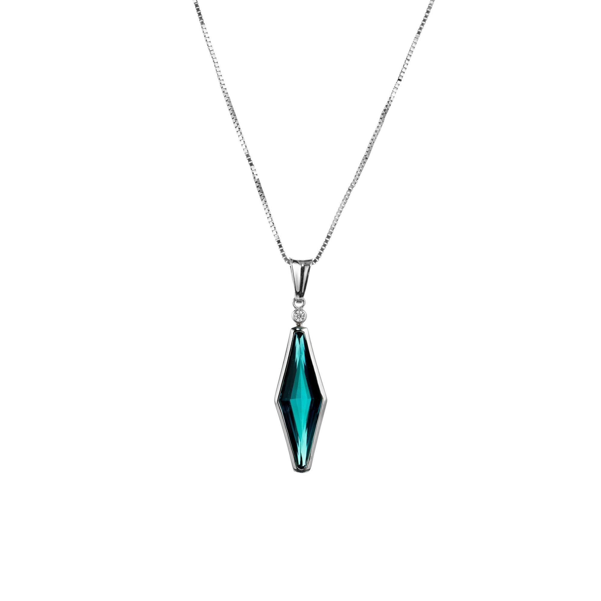Elongated Tourmaline and Diamond pendant necklace. This pendant is mounted with a blue green hexagon shape tourmaline. Bezel set in 18k white gold, this gemstone weighs approximately 4.95cts. Accented with one round brilliant cut diamond. The 18k