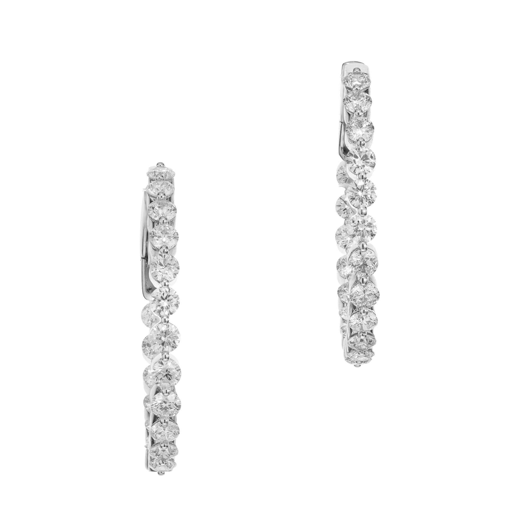 Beautiful Inside out diamond hoop earrings. These stunning 18k white gold hoops are set with 40 round brilliant cut diamonds, in side and out, with a total carat weight of 5.00.  1.5 Inch wide with extra safe and secure locking clip backs. Designed