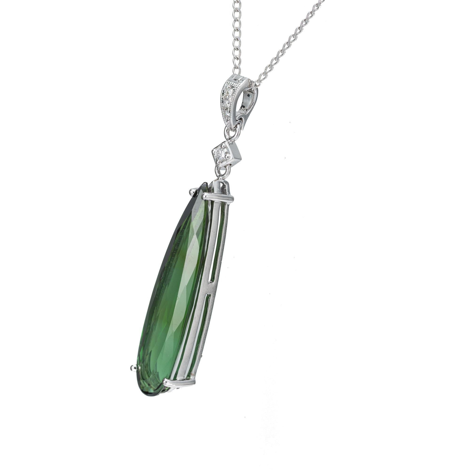 Green elongated pear shape tourmaline in a simple 14k white gold pendant setting with four diamond accents and an enhancer bail. 16 inch long chain. Designed and crafted in the Peter Suchy workshop. 

1 elongated pear shape green tourmaline, VS
