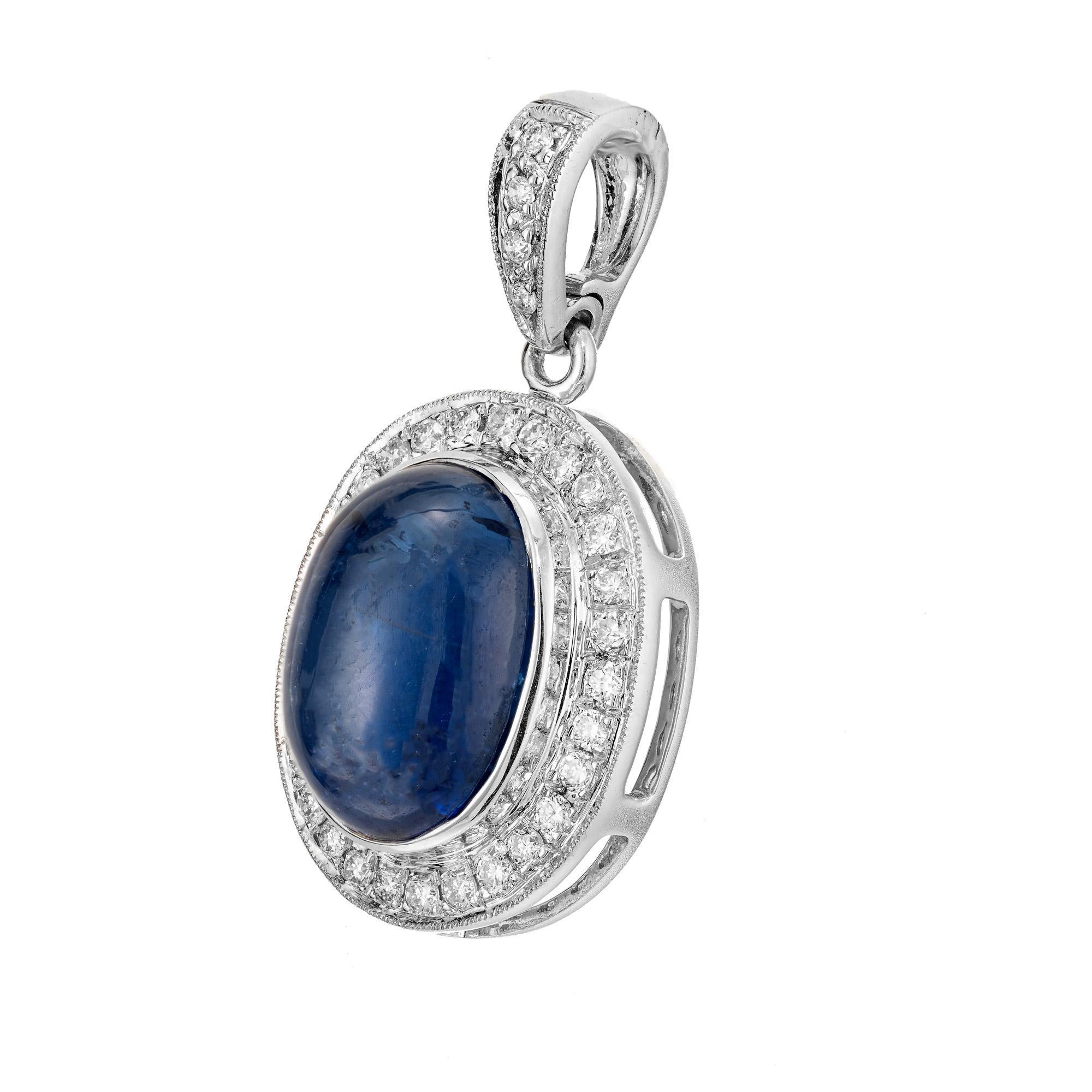 Oval sapphire and diamonds halo pendant.  Cabochon center sapphire set in 18k white gold with a halo of 33 round cut diamonds. The sapphire is from an early 1900's estate. The setting was created in the Peter Suchy workshop. 

1 oval sapphire