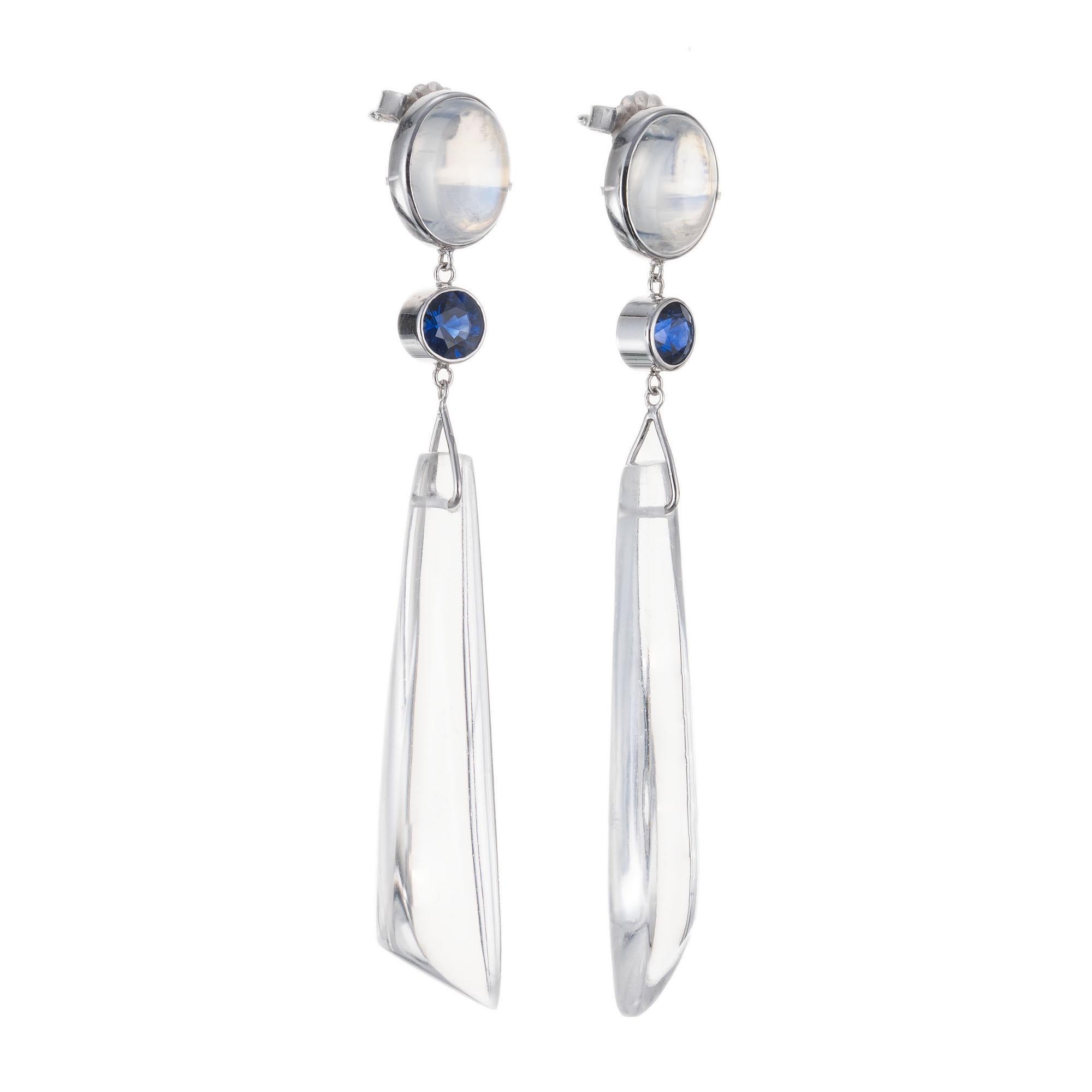 Peter Suchy moonstone and sapphire dangle drop earrings. 2 oval moonstone tops with 2 round sapphires below with 2 pointed clear natural quartz tiers. Handmade in 14k white gold. 

2 oval cabochon clear iridescent blue moonstones, VS approx.