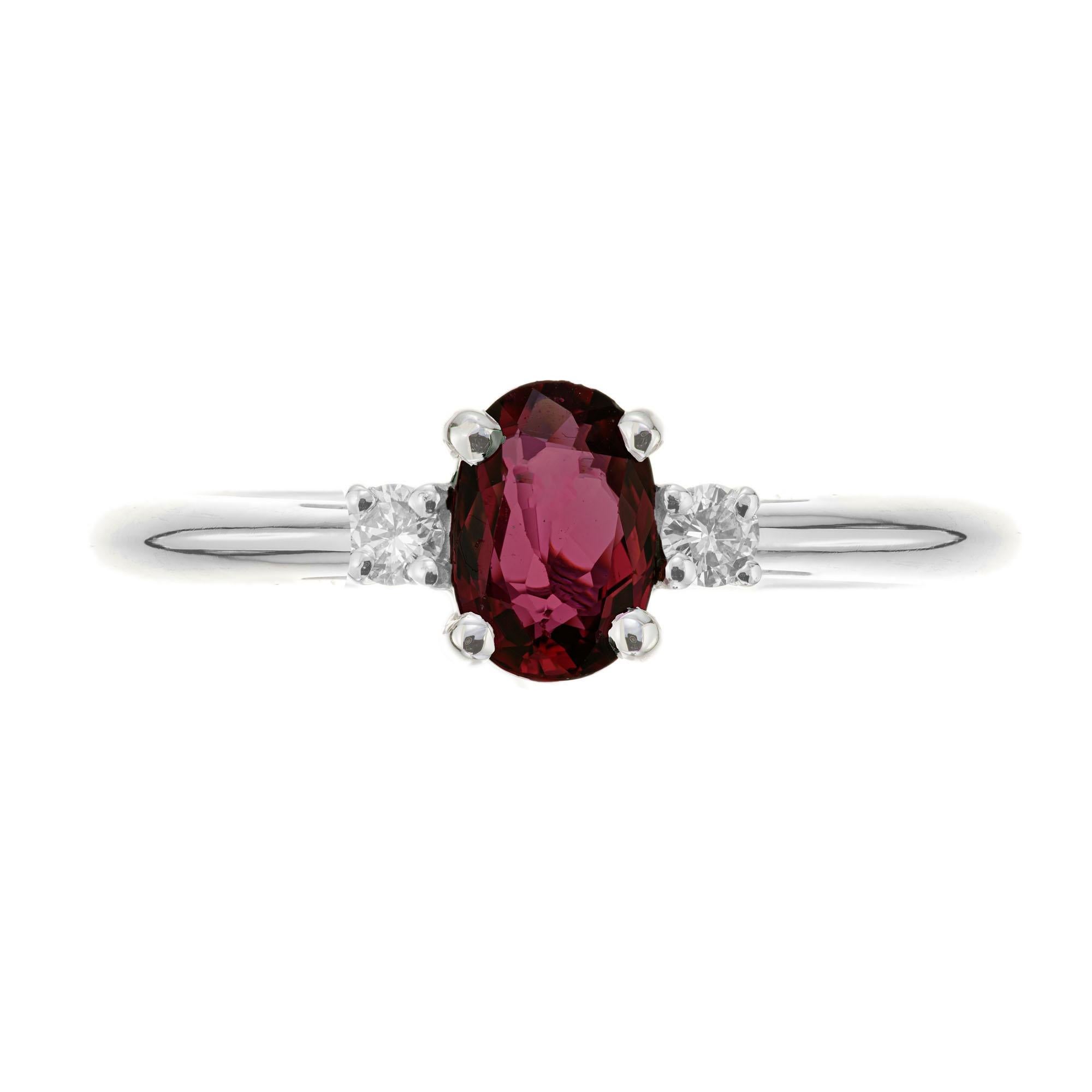 Ruby and diamond engagement ring. Oval ruby center stone with 2 round brilliant cut side diamonds in a 14k white gold three-stone setting. Designed and crafted in the Peter Suchy workshop.

1 oval red ruby, SI approx. .58cts
2 round brilliant cut