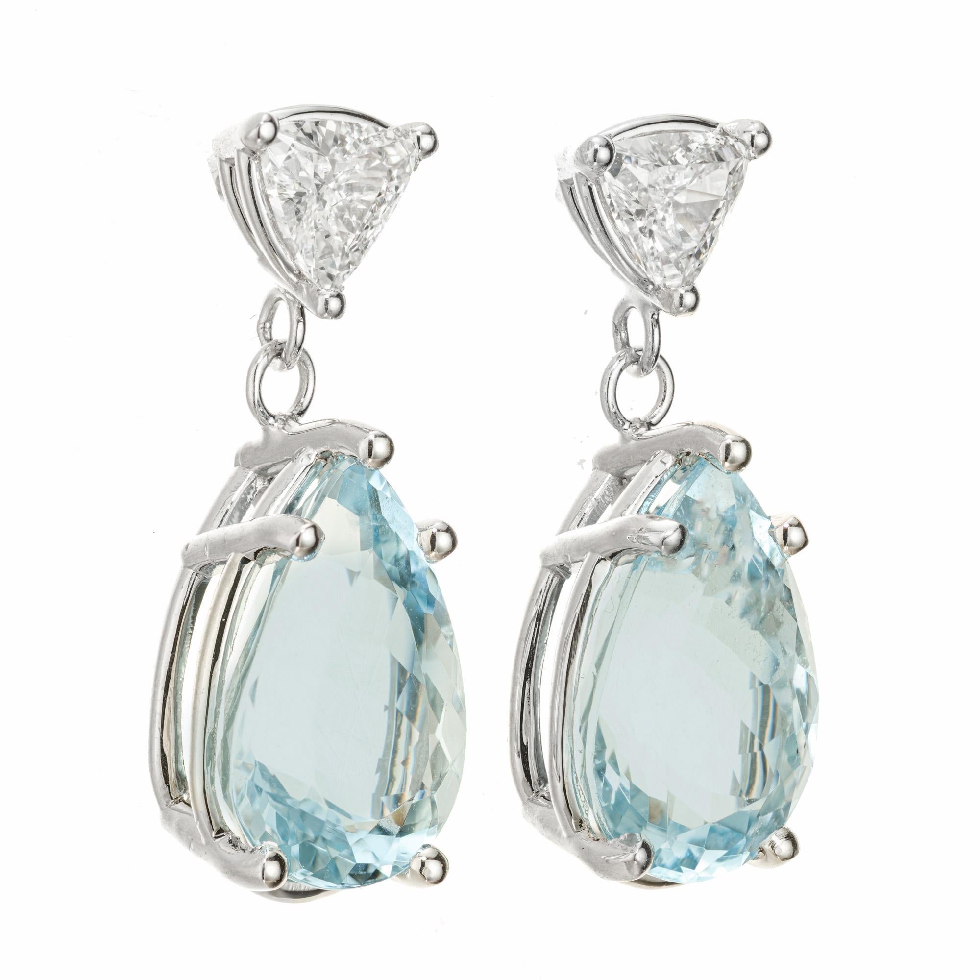 Art Deco inspired. Aqua and diamond earrings. 2 trilliant cut diamonds, each with a pear shaped bright aquamarine dangle. Both totaling 5.80 carats in 14k white gold settings. Designed and crafted in the Peter Suchy Workshop. 

2 pear shape blue