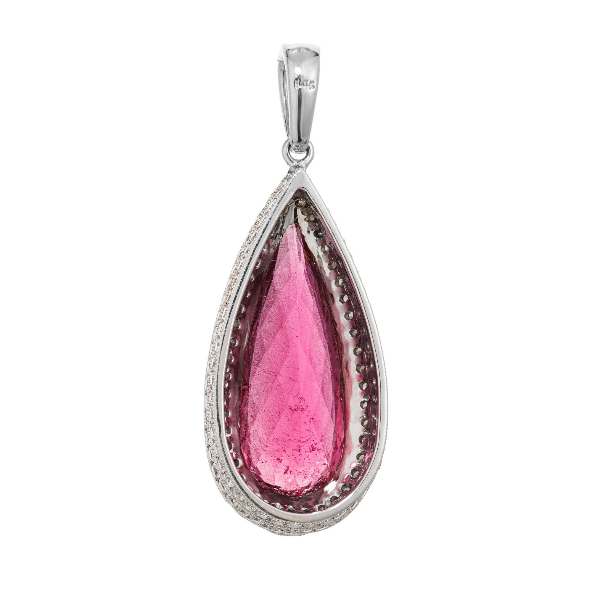Pink Tourmaline Rubellite and diamond pendant. Beautiful 6.06ct rich and deep pink pear shaped tourmaline with a halo of round cut diamonds set in 14k white gold. Along with the halo, two additional rows of round cut diamonds run along the sides of