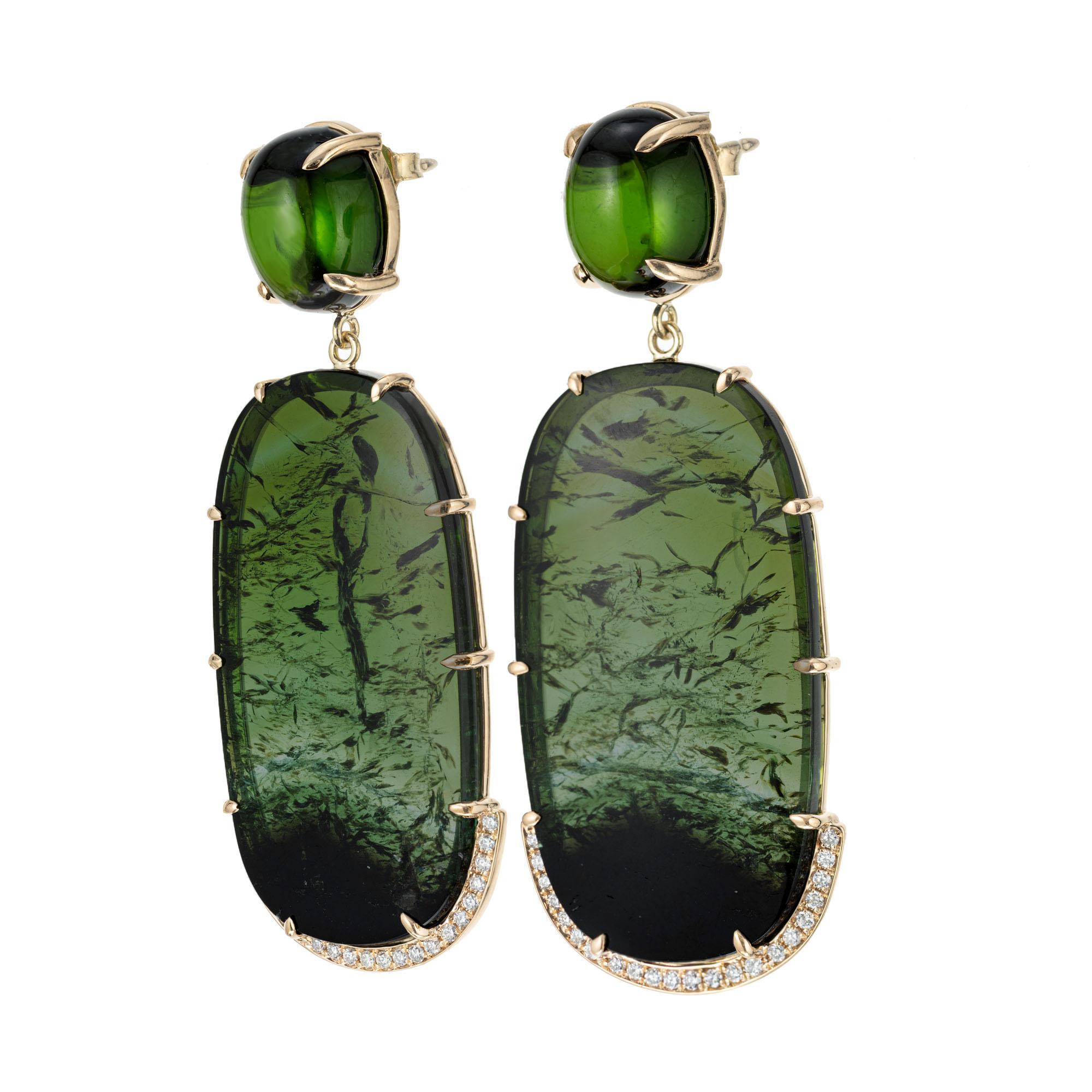 Natural tourmaline and diamond dangle earrings. Handmade in 18k yellow gold frames with oval tourmaline dangles accented with 44 round brilliant cut diamonds. Two oval cabochon tourmalines tops. Designed and crafted in the Peter Suchy workshop.

2