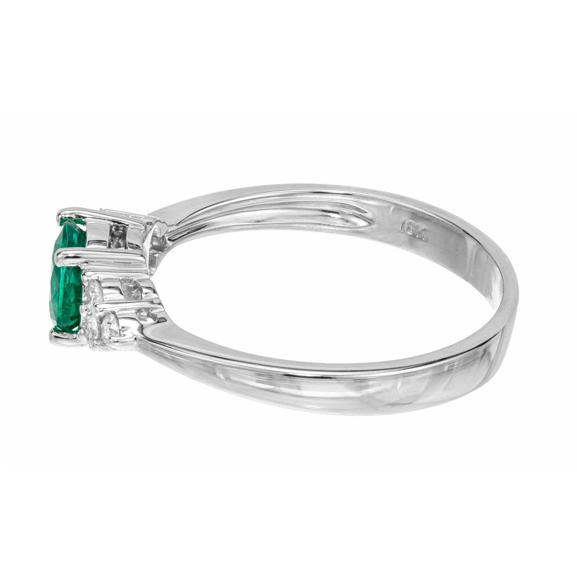 Emerald and diamond engagement ring. .68cts. round rich green emerald in a center stone set in a 18k white gold setting complemented with 3 round cut diamonds on each side of the stone. Designed and crafted in the Peter Suchy Workshop.

6 round
