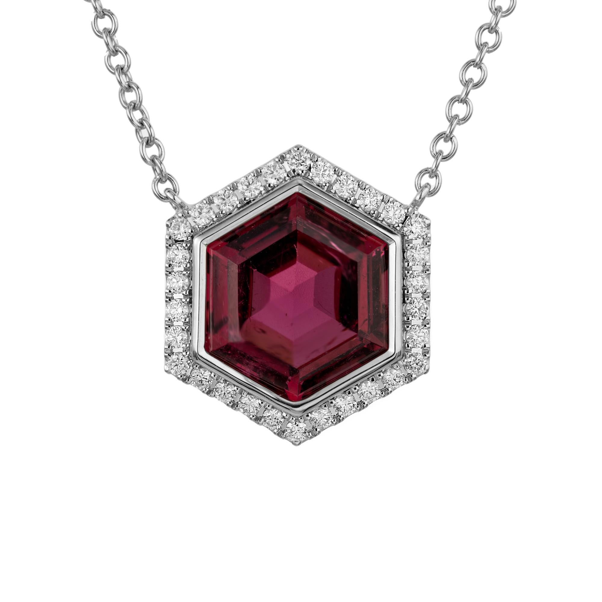 Deep, rich pink 6.82 carat hexagonal cut tourmaline in a six sided diamond halo 14k white gold pendant setting. This stunning tourmaline is enriched by a dazzling halo of 30 round brilliant cut diamonds that encircles the center stone, each one