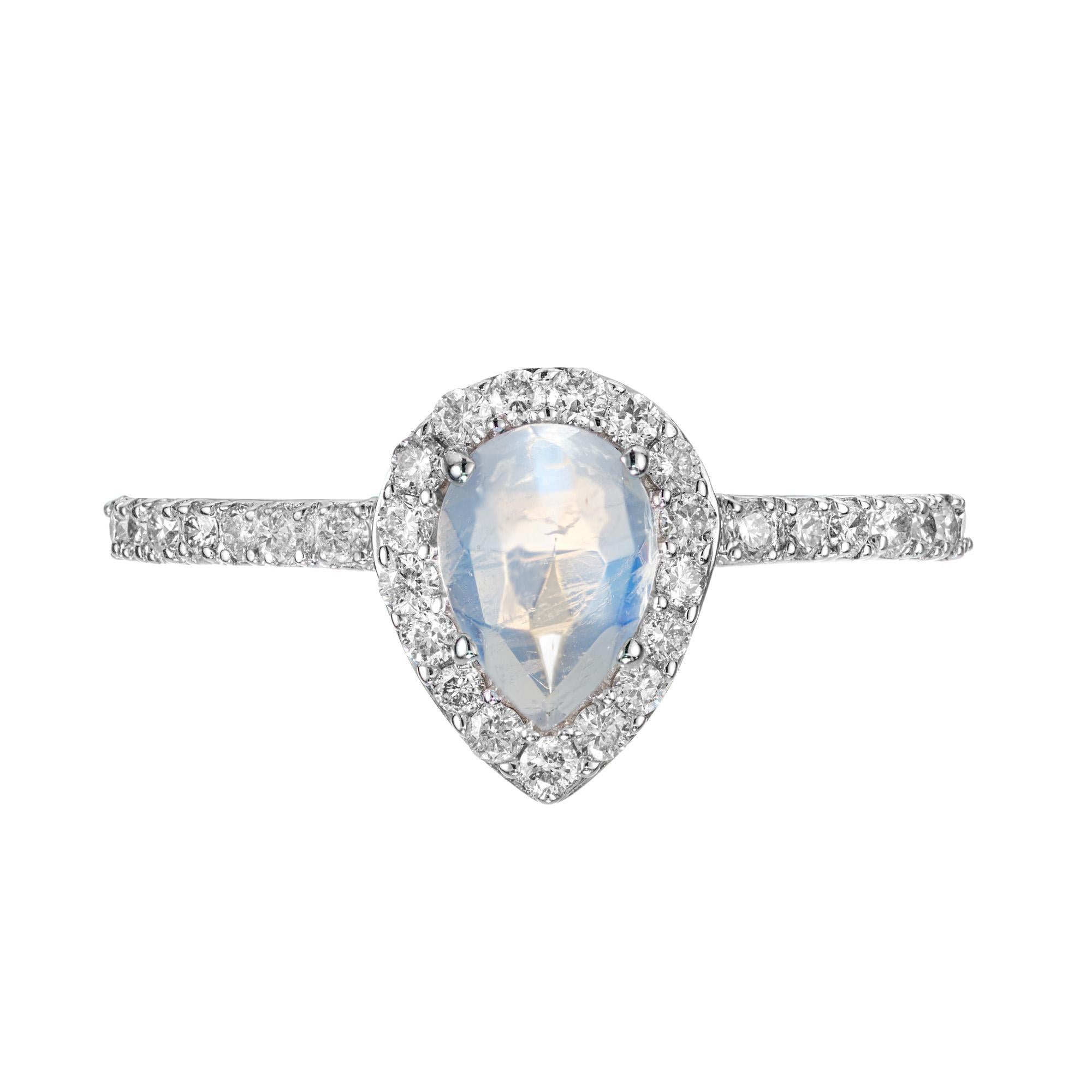 Pear shape diamond halo ring. .70cts Pear shaped bluish/white faceted cabochon moonstone center stone, set in a 14k white gold setting with a halo of round cut diamonds which are enriched with accent diamonds along the shank. Designed and crafted in