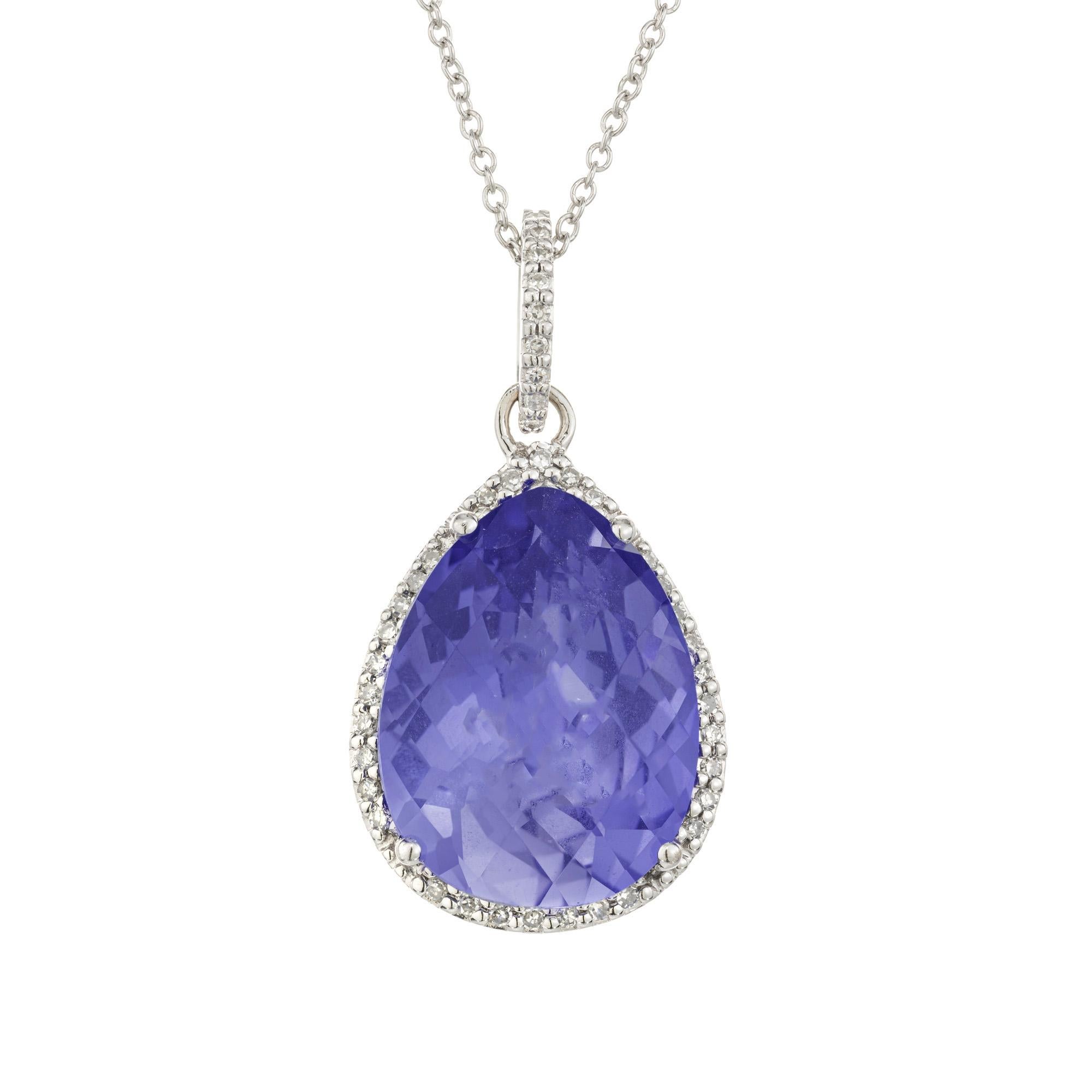 Exquisite tanzanite and diamond pendant necklace. This pendant begins with its center stone, a faceted pear shaped blue with purple hue 7.00ct tanzanite. Set in a 14k white gold setting, the tanzanite is framed with a halo of 42 single cut
