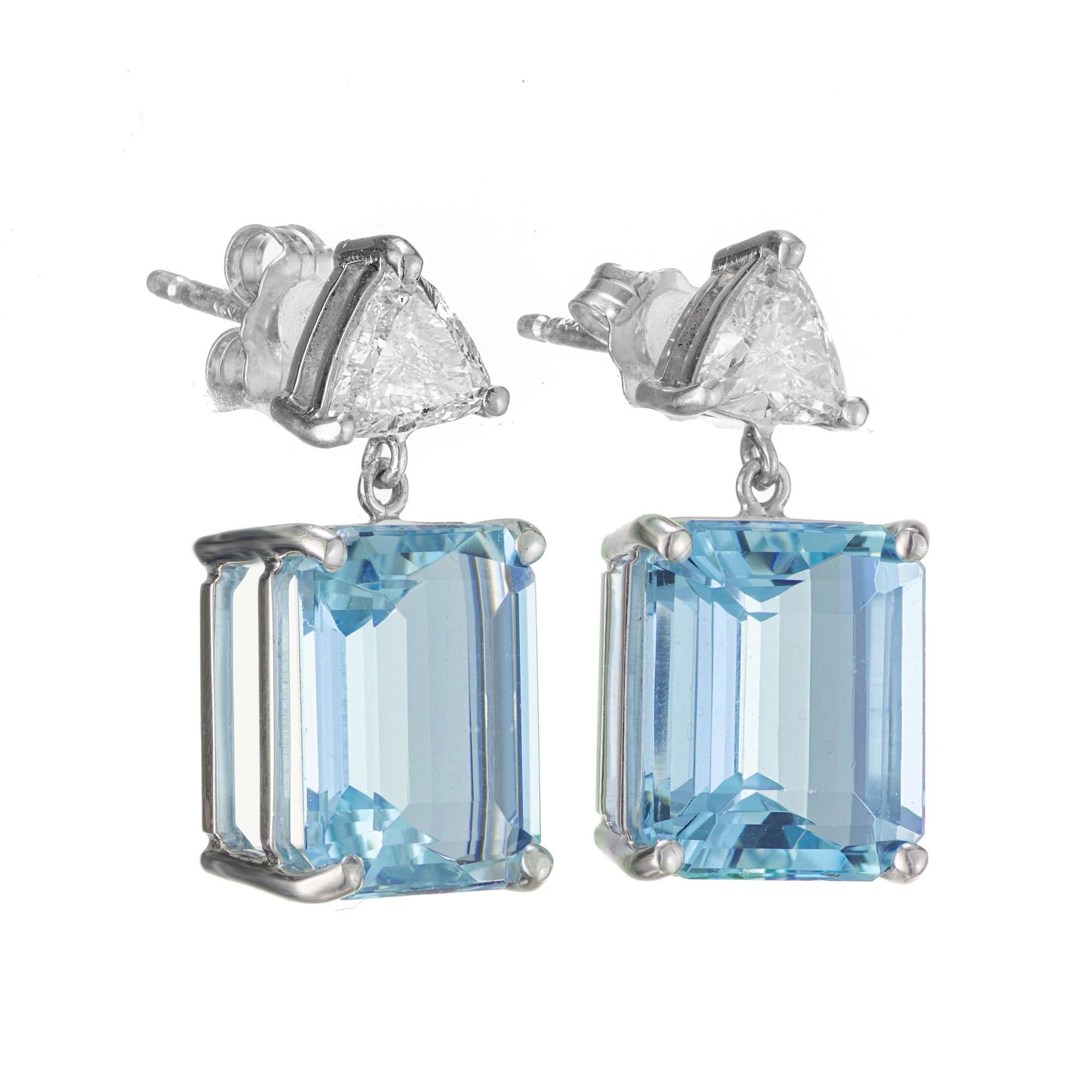 Aquamarine and diamond dangle earrings. 2 emerald cut vibrant blue aquamarines totaling 7.06cts set in 18k white gold four prong settings, complemented with 2 trilliant cut diamonds. These beautiful aquas are from a 1940's estate and with the