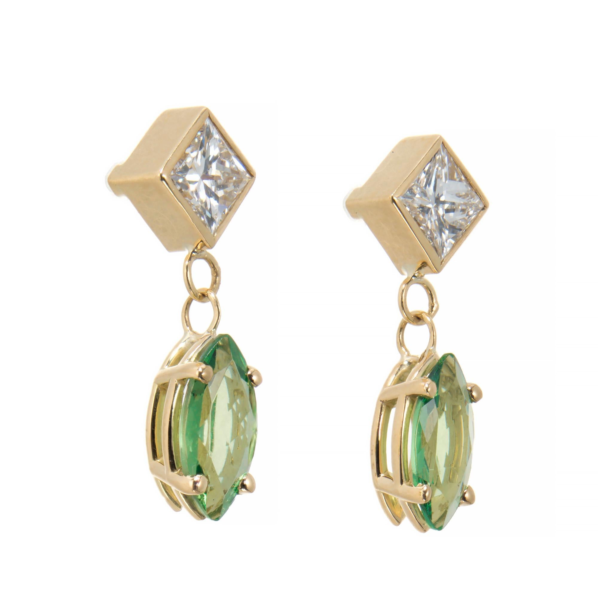 Tsavorite garnet and diamond dangle earrings. Two bright green marquise tsavorite garnet dangles set in simple four prong settings, accented with two white brilliant princess cut diamonds set in yellow gold bezels. Designed and crafted in the Peter