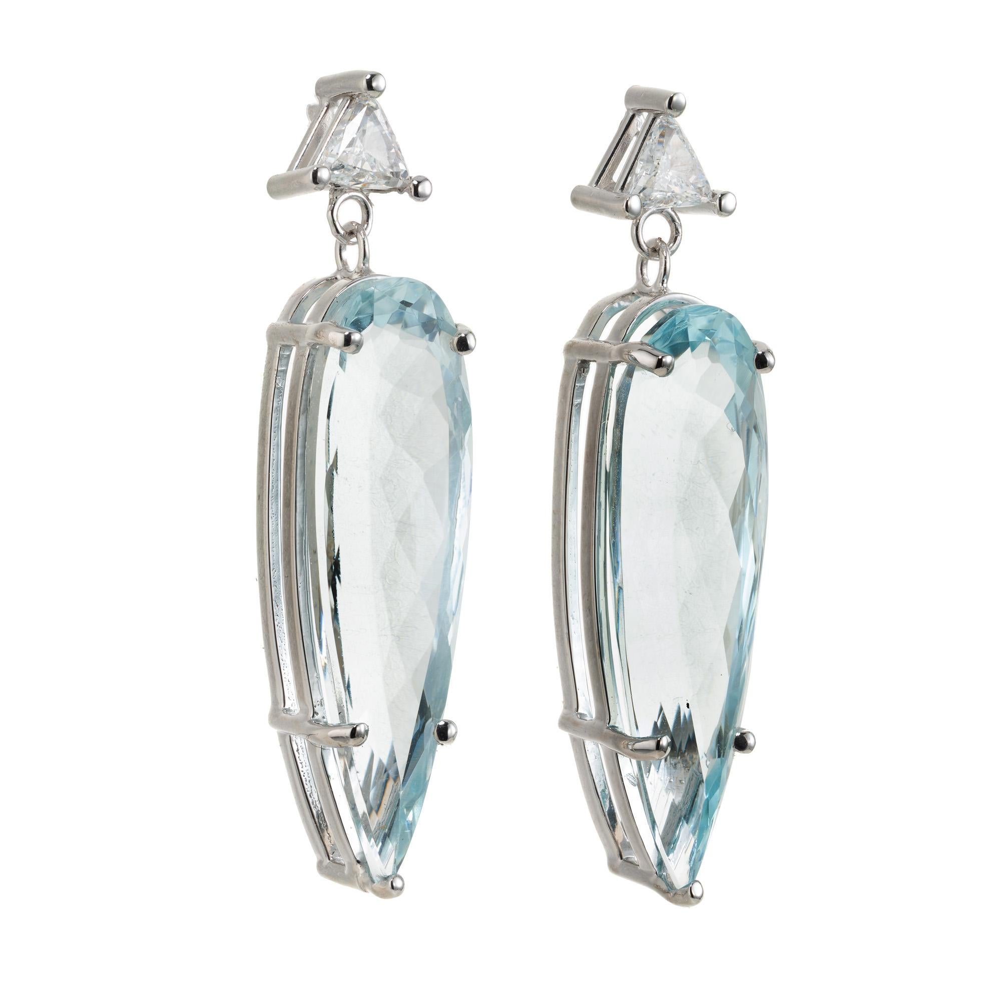 Wonderful matched pair of soft natural blue pear shaped aquamarines circa 1950's fabricated into a classic dangle earrings with trilliant diamond tops.  The focal point of these earrings are the two breathtaking 7.39 carat pear-shaped aquamarine
