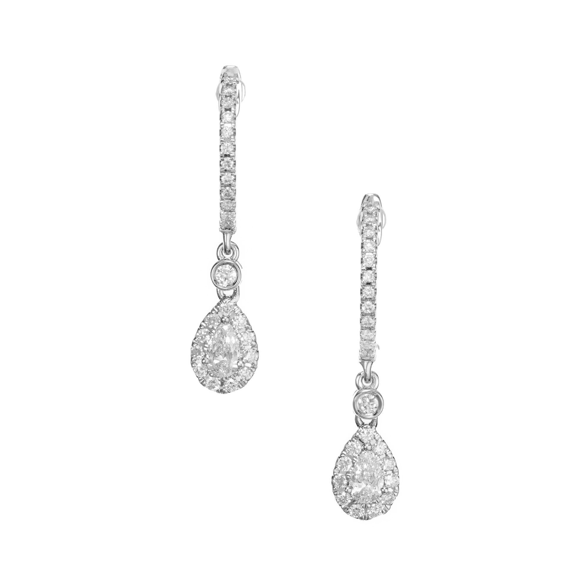 Diamond dangle hoop earrings. These simple but elegant earrings are made up of 2 pear shape diamonds totaling .24cts, each with a halo of round cut diamonds, connected to lever back hoop by a single bezel set round diamond. Both the fronts of each