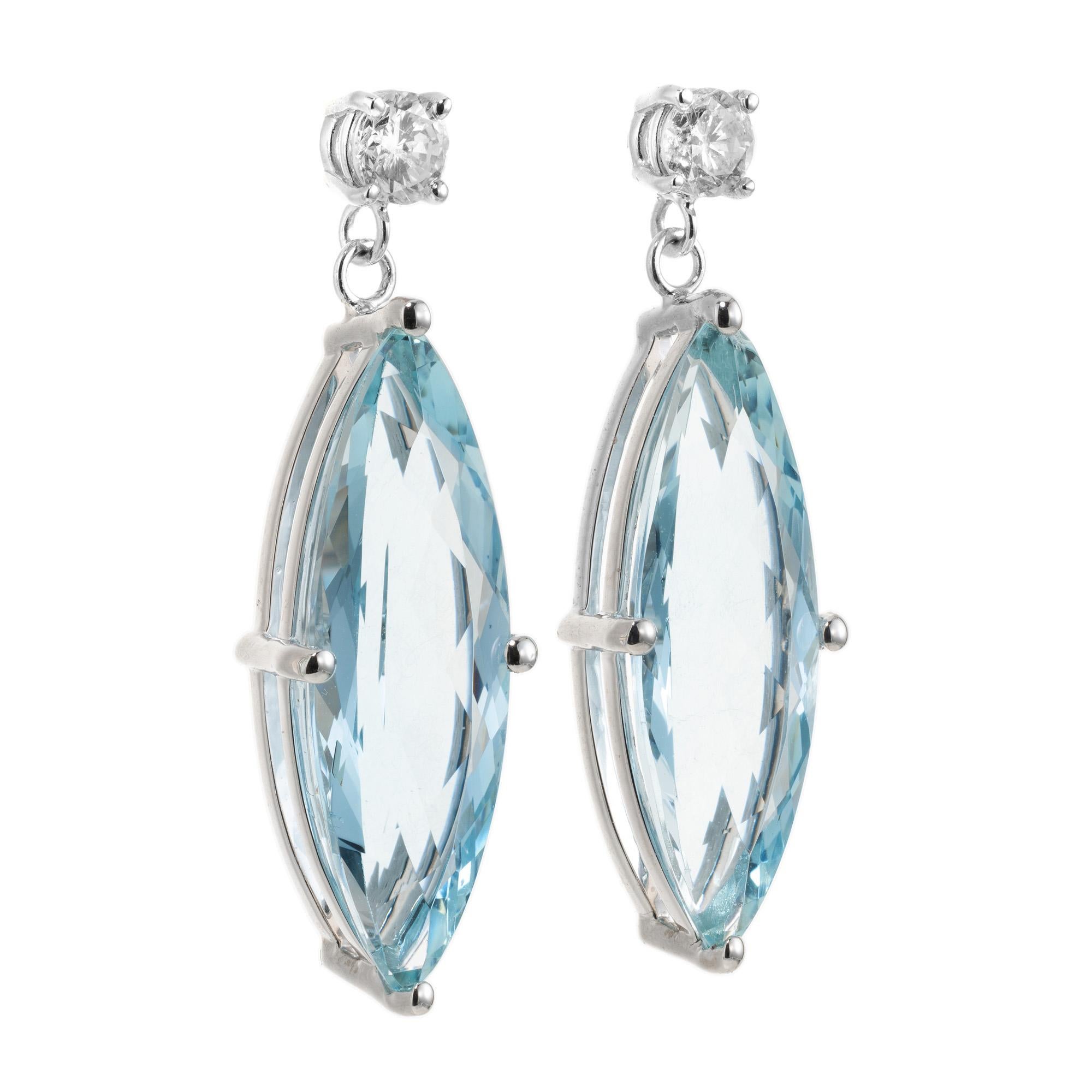 7.49 Carat Aquamarine Diamond White Gold Dangle Earrings. The centerpiece of these earrings are two exquisite marquise  aquamarine gemstones with a captivating pale blue hue. The aquamarines are beautifully accentuated a round cut diamond at the top
