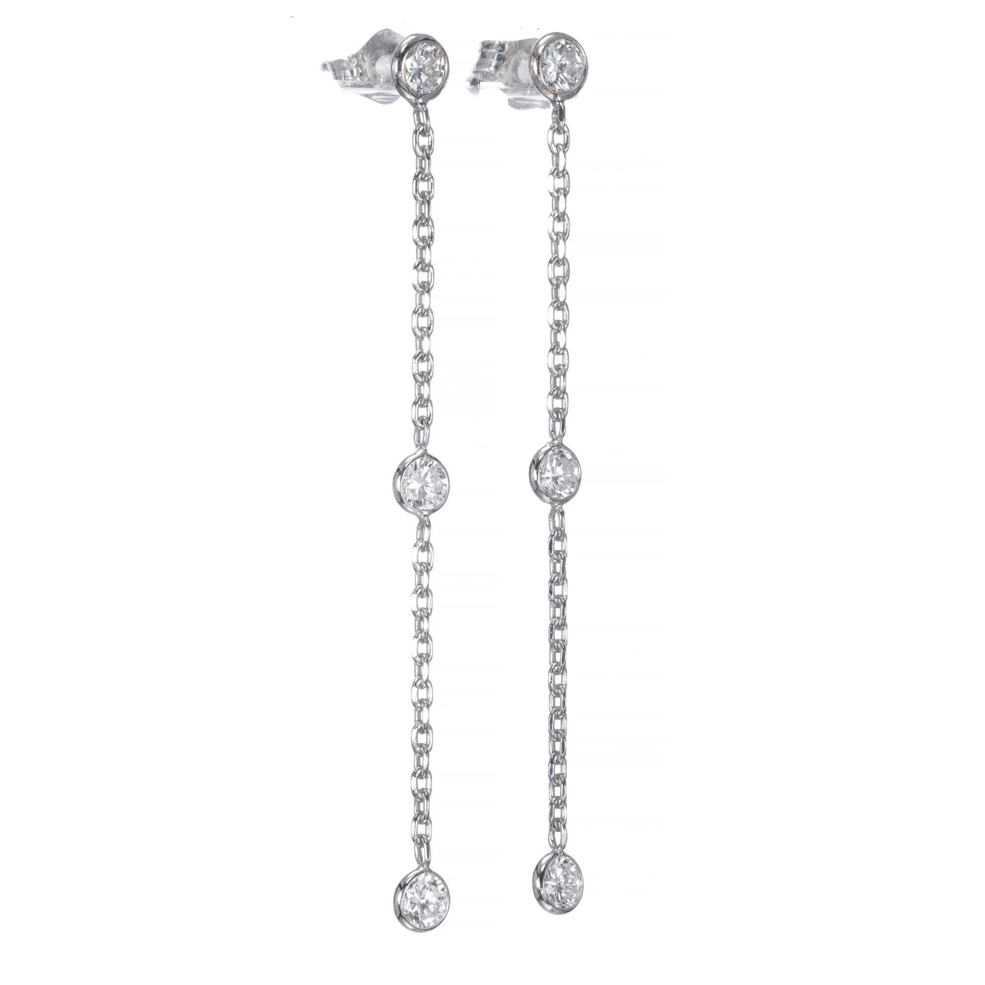 Diamond dangle drop earring. 6 diamond bezel set diamonds in 14k white gold.

6 full cut diamonds, approx. total weight .75cts, G to H, VS2 to SI1
14k White Gold
70 grams
Top to bottom: 1.88 inch or 47.84mm
Width: 3.5mm