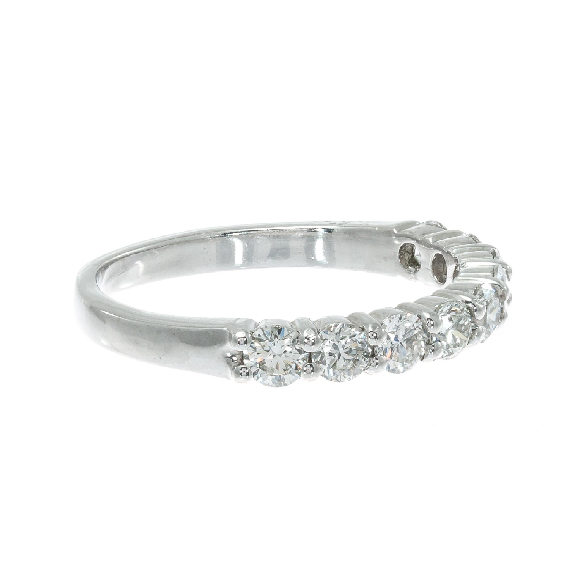 Nine bright sparkly ideal cut diamonds in a platinum wedding band ring made in the Peter Suchy Workshop

9 round brilliant cut F VS diamonds, Approximate .75cts 
Size 7 and sizable 
Platinum 
Stamped: PLAT
3.9 grams
Width at top: 2.96mm
Height at