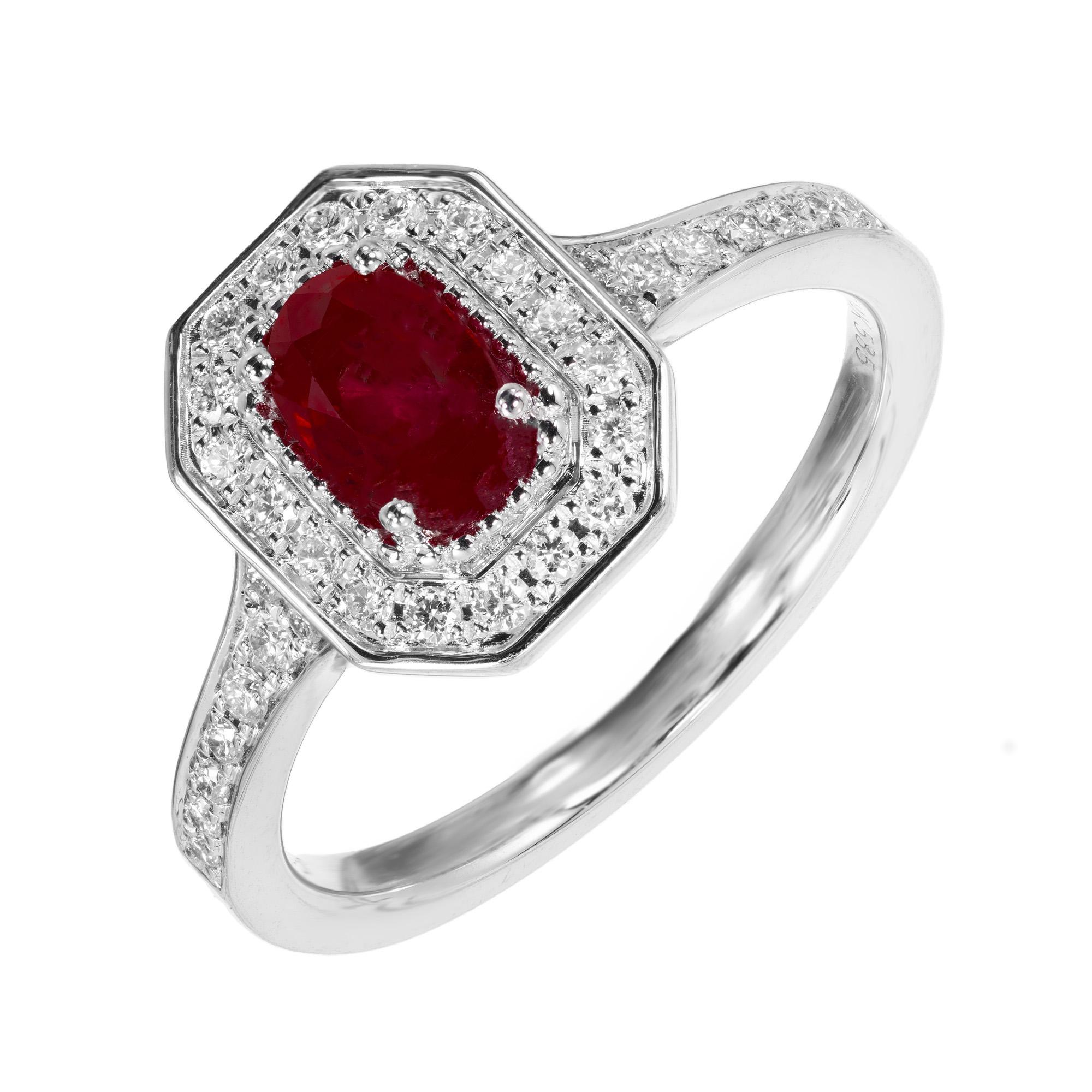 Oval ruby and diamond engagement ring. .77ct oval center ruby, mounted in a 14k white gold octagonal setting with a halo of round brilliant cut diamonds. Accent diamonds also run along both shoulders. Designed and crafted in the Peter Suchy